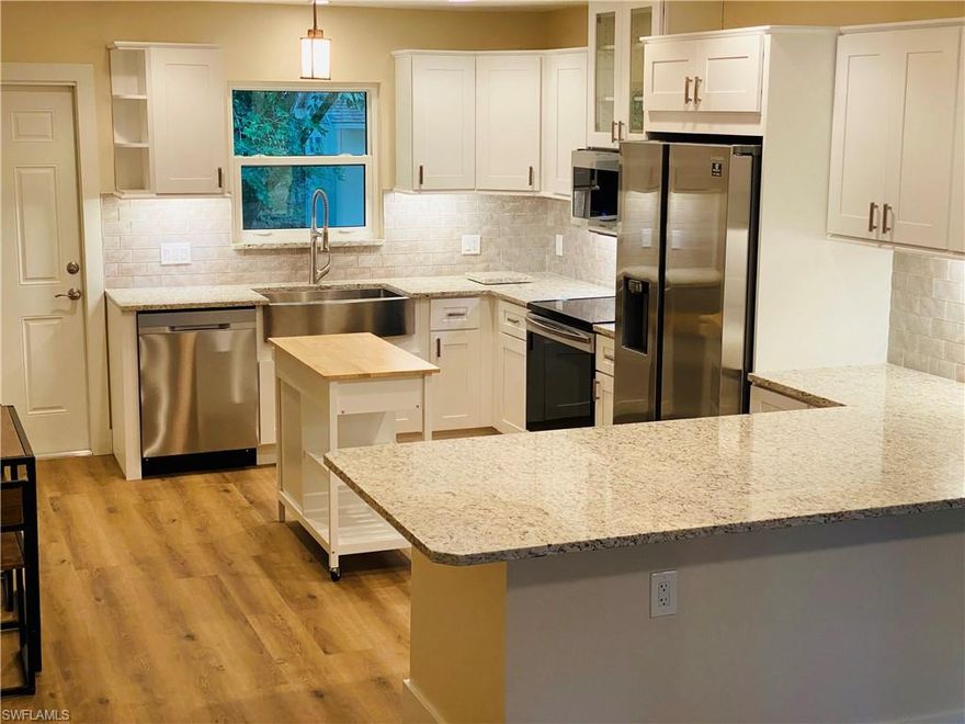 Only a few minutes away from downtown Naples and the beach.  Absolutely gorgeous 2.25 acres, with a nearly perfect, move-in-ready house.  Mass producing mangos and starfruit trees.  Towering pines.  BIG live oak trees.  One HUGE Royal Poinciana tree in the front yard and lots of other subtropical trees, plants and palms.  This is a concrete block home with impact windows and is like a hurricane fortress.  Let’s stay friends, so that after you buy this house and the next hurricane hits, I can bunk at your place.  The lot is 200ft wide in the front half and 630ft deep.  Behind the house is an ac'd workshop/shed.  The land gives you plenty of room to add… whatever you can imagine!  No expensive worries on these key features… New roof.  New impact windows. New air conditioner.  New water system.  New 100’ well. New attic insulation.  New kitchen cabs.  New granite counters. New bath vanity.  New appliances.  New flooring.  And more.  Didn’t I mention the house is nearly perfect?  Add it all up, and you cannot beat this price for a great house on a superb parcel of land in a perfect location.  You will not be disappointed with what you will see here.  The pictures don’t lie.