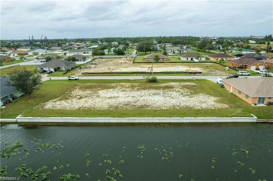 This exceptional multi-family zoned lot offers 200 feet of lakefront on the scenic shores of LAKE KENNEDY in beautiful Cape Coral, Florida. With water and sewer assessments fully paid and a BRAND NEW SEAWALL, this property is development-ready and perfectly suited for investors or builders looking to create a premier project. Lake Kennedy, part of the sought-after Seven Lakes Chain, provides tranquil water views and access to boating, fishing, and recreational activities, making this location ideal for residents who enjoy an active lifestyle. The generous lakefront footage offers plenty of space for multiple units to enjoy serene water views, as well as plenty of space for a large shared outdoor area or dock. Cape Coral’s thriving community, excellent schools, and proximity to shopping, dining, and entertainment enhance the lot's value, making it an ideal investment opportunity. Don’t miss this chance to build on one of the area’s most desirable lakes and bring your project vision to life in the heart of Cape Coral!