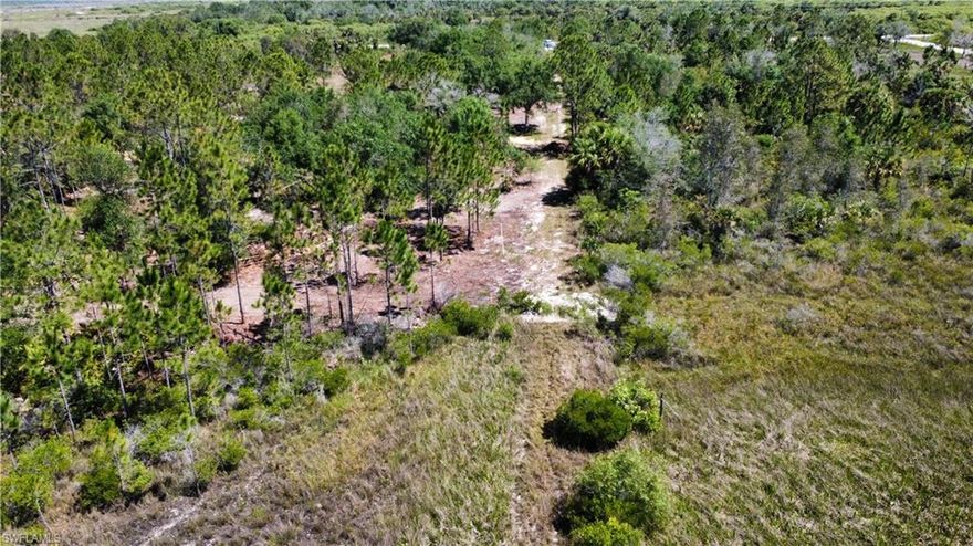 5 WOODED & partially FENCED acres of TOTALLY PRIVATE homestead land situated directly off a gated, semi-private gravel access road just 750’ off the main paved SR74 inside Charlotte Harbor Highlands. This parcel has a small pond on the East end with almost nothing but untouched parcels surrounding it.   The FPL power lines & cable/ wifi are 750’ away at SR74 making it a direct line to the parcel. This is THE nicest smaller parcel in the area! The Highlands area it sits within, is a 2 mi platted, subdivided & recorded section with legal 60' ingress/egress easement access roads with no deed restrictions & limited only by AGRIGULTURAL zoning ( AG allows over 100 uses including 1 SFR or mobile home & multiple outbuildings/ barns… conservation, recreation & other uses including horses, livestock & farming) The soil is an Oldsmar fine sand which is ideal for garden or pasture & the elevation is about 60 feet. Septic/well would be required if building. Sold AS-IS with full & clean title. Watch drone video for full parcel detail. Call for specific details, access authorization & instructions. FINANCING AVAILABLE THRU FARM CREDIT or LMCU.