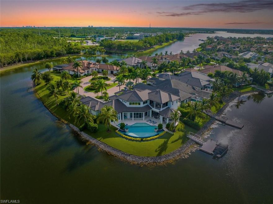 The ultimate waterfront lifestyle awaits in this exclusive Estate property with private dock in Miromar Lakes Beach & Golf Club.  Perfectly designed on a private peninsula waterfront homesite, this magnificent 5-bedroom residence showcases exquisite architectural details. The centerpiece is a soaring, open-concept great room with grand chandelier & lighted 24-foot dual-sided linear gas fireplace. Design features include white oak wood flooring, tongue-and-groove and wood beam ceiling details, designer tile, open concept gourmet kitchen, butler’s pantry, and back-up generator. The primary suite offers a gracious bath with dressing area, steam shower, 3 walk in closets including a hers dressing room and separate entry. The second-floor with elevator access includes a game room, en suite bedroom, and open-air balcony. The outdoor oasis offers living room, fireplace, cooling system, electric screens, fully turfed yard with sprinkler system, wrap-around bar with grill and resort-style saltwater infinity edge pool, spa, outdoor shower, private dock. Tesla charger, AC garages, and home gym which can be converted back to additional garage. This is the perfect property for a discerning buyer looking to immediately begin enjoying the Miromar Lakes lifestyle and its unparalleled waterfront living. As the only southwest Florida community with miles of beach, boating, golf, and resort-style amenities in one picturesque destination, it offers a truly remarkable lifestyle. Water-ski, paddle board, kayak, sail, or fish on the 700-acre freshwater lake, unwind at the wellness spa, play the Arthur Hills “Signature” championship golf course, hone your tennis, or pickleball skills, or simply relax in the dreamy beachfront cabanas. Located minutes from Southwest Florida International Airport, world-class beaches, shopping, and dining.