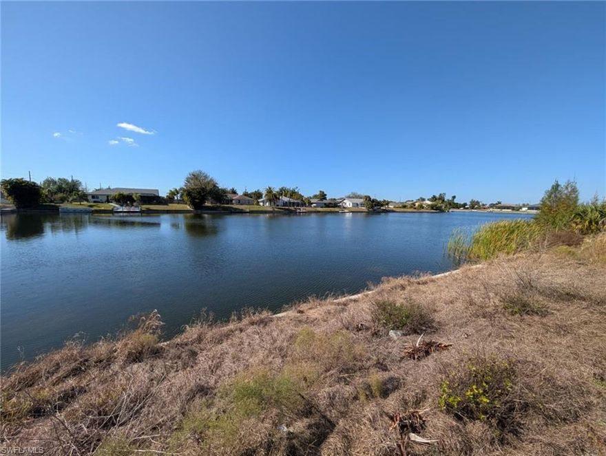Discover the perfect location to build your dream home on this freshwater waterfront lot in beautiful Cape Coral. Situated on an extremely wide freshwater canal, this property offers stunning water views. The lot features a newer seawall, saving you significant construction costs and giving you a head start on building. Located in a growing area of Cape Coral, this property offers easy access to shopping, dining, schools, and all the amenities Southwest Florida has to offer. This area of Cape Coral is already connected to city water, so no need to install a costly well system! Whether you're planning to build now or invest for the future, this waterfront homesite is a fantastic opportunity. City water is already in place so no need to build a costly well! Don't miss your chance to own a piece of paradise with wide canal views, and a newer seawall already in place.