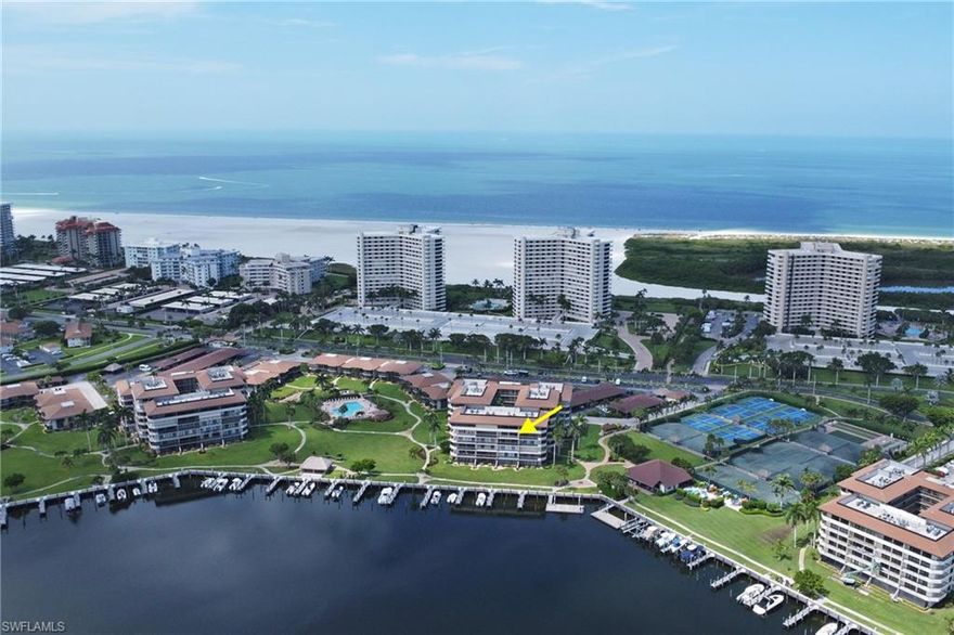 Presenting this MUST SEE Condo in the rarely available South Seas East on Marco Island!  Live, Vacation or Invest in Paradise with this immaculately maintained 5th-floor coastal unit and take in the amazing views of the Bay where you can watch dolphins play and the Sunrise each morning, or open your front door to the Sunsets each evening. Your oversized private balcony is also accessible right from the primary bedroom. This 2 bedroom, 2 bathroom condo is all about relaxed yet active island living, with private gated beach access just outside from your doorstep. The condo includes in unit washer & dryer, and a highly desired transferrable covered carport parking space with extra storage for your beach gear. Located in the guard-gated community of South Seas, you’ll have access to resort-style amenities including available Boat Docks, Kayak Storage, heated swimming pools, tennis, pickleball, bocce, shuffleboard, golf putting green, cornhole, bicycle storage, and a cozy chickee hut for social gatherings. There are also walking and biking paths throughout the community. Whether you're relaxing on the balcony, enjoying the view, or heading out for a beach walk, this condo is the perfect blend of comfort, convenience, and coastal charm.