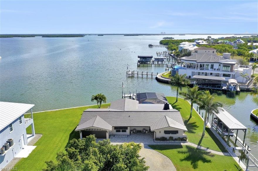 LISTING AGENT WILLING TO DO A "LIVE" VIRTUAL SHOWING FOR ANY QUALIFIED BUYER!   Delightfully decorated in a breezy coastal theme with a panoramic view of the Estero Bay. This home is located on a cul-de-sac on almost a ½ acre with approximately 300 feet of waterfront that wraps around the bay and intersecting side yard canal.  Remodeled in 2019, this home offers 3 bedrooms, 3 baths, pool/spa, 18,000 lb and 16,000 lb boat lifts with roofs and all new appliances in 2019.  The following improvements were added in 2018: new roof, electrical wiring/boxes and plumbing, new hot water heater and new air conditioner in the newly added 2 car deep garage. Enjoy coffee watching a beautiful sunrise, fish off your observation pier, take a 10 minute ride to the gulf of Mexico to go deep sea fishing or watch sunsets, walk a couple blocks to the beach or just relax poolside.  This home offers something for everyone’s entertainment. It’s a quick walk to the amazing white sugar sand beaches, close to restaurants, grocery store, night life and shopping. Schedule your private showing today!