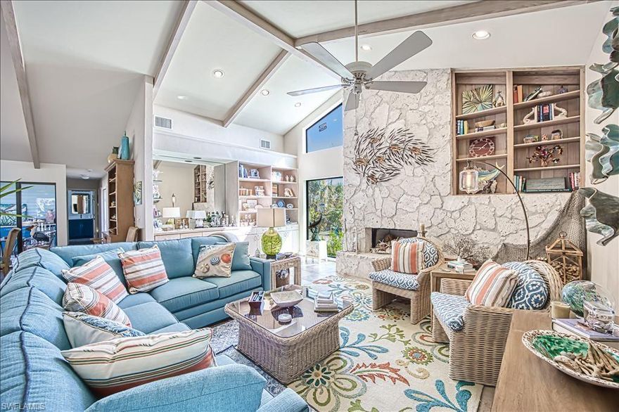 Cool, calm, and coastal, this beautiful island-inspired home is ideally situated in the prestigious Gulf Ridge beach community. Enjoy sun-filled days at the beach and unwind in the evenings by your private tropical pool oasis. Offering over 3,000 square feet of living space, the home features a thoughtfully designed split-bedroom floor plan with expansive living and dining areas overlooking the elevated, screened pool.

The great room is the heart of the home, highlighted by a striking coral stone fireplace, wet bar, and an open entertainer’s kitchen. A casual dining area invites family and friends to gather with ease.

Surrounding the pool, the covered lanai creates an exceptional outdoor living environment designed for both entertaining and relaxation. Accessible from the great room, living room, and primary suite, this space includes pool bath access, an extensive covered area, an outdoor bar, and a pass-through kitchen—perfect for spending the day in true island style.  4 bedrooms include a delightful owner's suite with a freestanding soaking tub and luxurious shower, dual sinks and tremendous storage.  The owner has connected the 4th bedroom to create a dressing and staging area. 

The unfinished lower level offers abundant storage for bikes, beach gear, and hobbies, along with a three-car tandem garage.

Recent upgrades include a new metal roof, remodeled kitchen and primary bath, renovated guest bath, impact windows, fresh interior and exterior paint, new front doors, an elevator lift at the entry, and extensive new landscaping that creates a lush tropical garden setting.

Gulf Ridge is known for its incredible landscapes and beautifully maintained grounds.  FOUR PRIVATE beach access points including 2 that accommodate ATV's.  2 community pools, tennis courts, and a kayak launch into Old Blind Pass and Bowman's beach