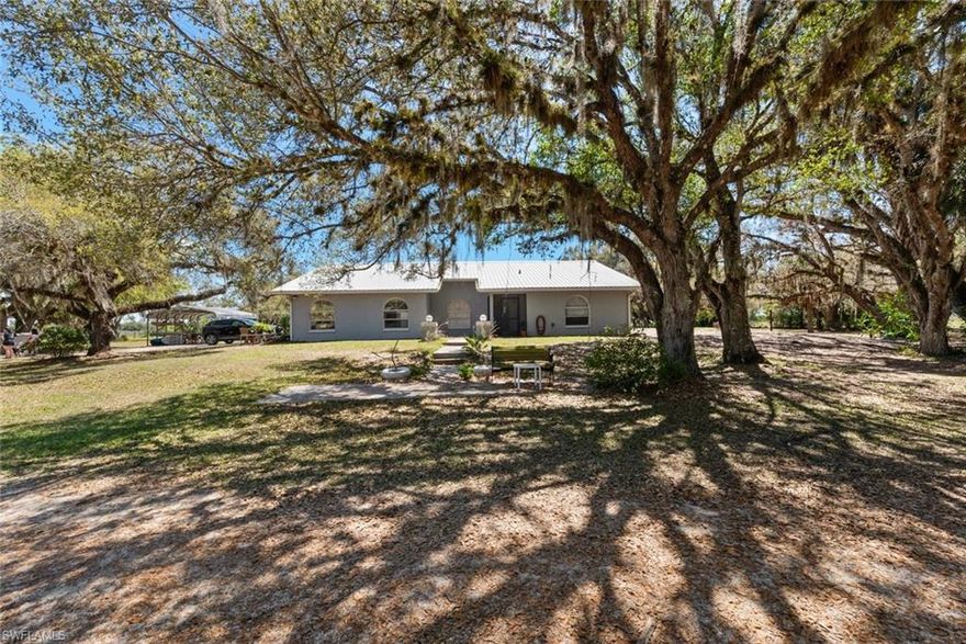 10 beautiful acres filled with mature oak trees just minutes from Labelle! This large single-family home has 3 bedrooms, 2.5 bathrooms, office/den, open kitchen, 2 HVAC's and 2570 sq feet of living! The fiberglass pool is easy maintenance and is perfect for relaxing on hot summer days. This property features two pole barns (43X51) & (27X23), a stocked pond, and is completely fenced and cross fenced. The metal roof ensures durability and longevity, while the covered lanai and newer screen enclosure allow you to enjoy the outdoors year-round. The septic drainfield has been recently replaced, providing peace of mind for years to come. Whether you're looking for a place to entertain guests or simply unwind in nature, this home has it all. Don't miss the opportunity to make this your forever home in Labelle. Schedule a showing today and experience the luxury and tranquility that this property has to offer. Adjacent 5 acres is also available. Click on the virtual tour-