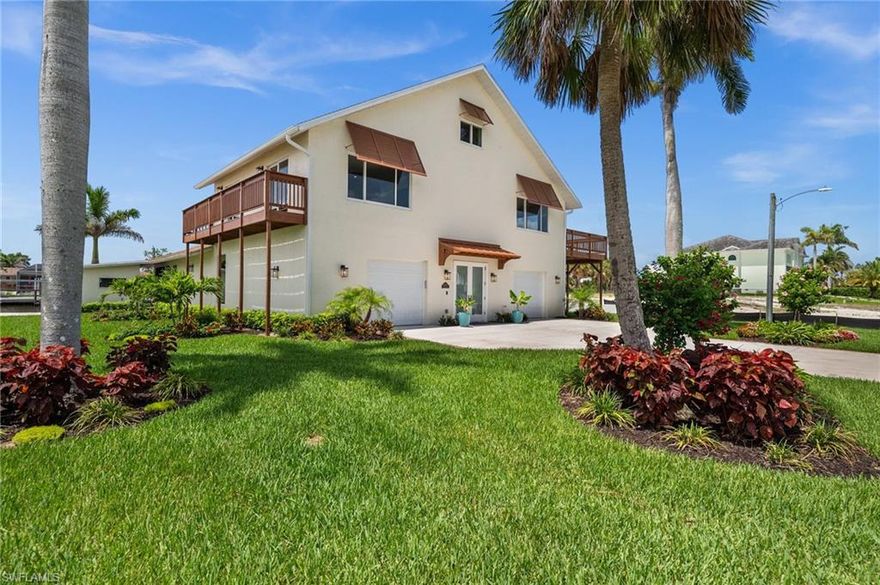 Experience the best of Florida waterfront living at 4837 Tarpon Ave in Bonita Springs. This beautifully updated SOUTHERN EXPOSURE home offers DIRECT GULF ACCESS, just 1500 feet by boat to the Imperial River, with 97 feet of waterfront, a private dock, and your own paved BOAT RAMP. Located west of US-41, it’s MINUTES TO THE BEACH! Bonita and Barefoot Beaches are a short bike ride away. Downtown Bonita Springs, Naples, Coconut Point, Mercato, and RSW Airport are all nearby. Inside, you’ll find over 3,400 square feet of FULLY RENOVATED living space featuring 4 bedrooms, 2 full bathrooms, and 2 half baths. The grand foyer sets the tone with modern finishes and double glass entry doors. The open-concept main living area features a gourmet kitchen with quartz countertops, a Wolf 8-burner gas range, Sub-Zero refrigerator, a large walk-in pantry, and oversized island with breakfast bar seating. The spacious 27x27 great room includes recessed lighting, tile floors throughout, and large sliding glass doors leading to a 45-foot screened lanai with 9' ceilings and extra storage. The second-floor owner’s suite is a true retreat, complete with a large private balcony, walk-in closet, and a spa-like bathroom with dual sinks, a glass-walled shower, and soaking tub. The two additional upstairs bedrooms also offer walk-in closets and private balconies. A bonus loft space is perfect for a gym, flex area, or a fourth bedroom with its own walk-in closet, ideal as a guest suite, media room, or private getaway. Outside you will experience lush landscaping with mature palms surrounding the oversized lot. A separate air-conditioned structure on the property serves as a PRIVATE OFFICE SUITE, complete with its own entrance and half bath, perfect for remote work or a creative studio. The home also includes a dedicated laundry room with Samsung pedestal washer and dryer, dual oversized one-car garages, and an impressive 34-foot-long climate-controlled storage room. With no HOA, a prime boating location near the Gulf, and upscale finishes throughout, this home offers a rare opportunity to enjoy luxury waterfront living with unbeatable convenience.