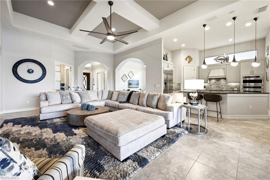 Arguably one of the most upgraded homes on a premium lot in Paseo, this exceptional cul-de-sac property offers over 3,000 sq ft with 4 bedrooms + den, 4 full baths, and a 3-car garage. Positioned at the end of the street with no neighboring homes to the right, this rare lot delivers a direct lake view plus protected preserve to the side—creating a private, quiet, sanctuary-like setting.

Designed for true Florida living, the expansive screened lanai features a fully equipped summer kitchen with built-in grill, mini fridge, wine cooler, and ice machine, along with generous covered entertaining space and room to relax in the sun. The pool enjoys full sun exposure all day, year-round—ideal for both lounging and hosting. Electric shutters on the lanai and impact windows throughout provide peace of mind.

Offered turnkey furnished, the home is professionally decorated with high-end furnishings, gorgeous lighting fixtures, and quality finishes throughout. Inside, you’ll find soaring ceilings with tray details, art and entertainment niches, and tile flooring throughout—no carpet anywhere. The kitchen is well-appointed with stainless Monogram appliances and a double oven.

Thoughtful upgrades continue with a custom mudroom with built-in bench and designer tile work, motorized window treatments, custom closet organization in the primary suite, and a rare double washer and double dryer setup—perfect for hosting family and guests. One guest wing features a convenient Jack-and-Jill bathroom, and the air-conditioned single-car garage adds flexible space for hobbies or additional storage.

Located in one of Paseo’s most desirable sections, this is a true move-in-ready property with a premium lot, exceptional privacy, and every upgrade already in place.

Paseo’s award-winning Village Center delivers a true resort-style experience right in your backyard. Residents enjoy 6 tennis courts, 2 pickleball courts with 3 more coming, bocce ball, a basketball court, and a full-service fitness center, along with a resort-style pool, lap pool, kiddie pool, and relaxing spa. The Tiki Bar serves food and drinks poolside, while the Pub offers a lively bar atmosphere with billiards. Additional amenities include an ice cream shop, private movie theater, formal dining, and a full calendar of social activities—creating a vibrant, vacation-like lifestyle year-round.