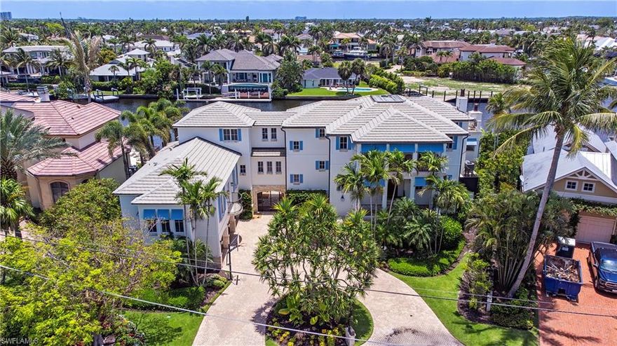 New homes in the neighborhood asking $25m+. This is a beautifully designed custom-built home on one of Aqualane Shores premier locations a
short distance to the beach and historic Old Naples’ 3 rd Street shops and dining. Positioned on a wide waterway with 148
feet of frontage, this property offers ample opportunity to enjoy direct, unrestricted access to Naples Bay and the open
waters of the Gulf. The interior design by Collins Dupont is both elegant and timeless while personifying the perfect
Naples beach home. With 6,774 square feet under air and 12,552 square feet under roof, this comfortable home offers
generous, well-proportioned spaces and a flowing floor plan filled with an abundance of natural light and stunning views
from every room. Perched on a high elevation, this concrete block home with poured concrete floors offers exceptional
structural integrity. The ground floor features a circular driveway, two oversized garages with space to accommodate 4+
vehicles, and a vast open area leading to the covered lanai, resort-style heated saltwater pool and spa, and an expansive
summer kitchen. The primary suite with dual water closets, a guest suite, and the den are all located on the first floor of
living. The gourmet kitchen has a large center island, butler’s pantry, and sweeping waterfront views. The top floor has 4
large ensuite bedrooms and a 400+ square foot game room leading out to a large balcony overlooking the Aqualane
Shores waterfront. This stunning residence possesses every feature you would expect in a home of this magnitude
including a whole house generator (connected to natural gas lines), a newly installed latest version Control4 home
automation system to run almost every function of the home remotely, roll down screens and shutters, and elevator
access to the entire home. This residence is designed for those who value exceptional craftsmanship and custom design.
Furnishings are negotiable.