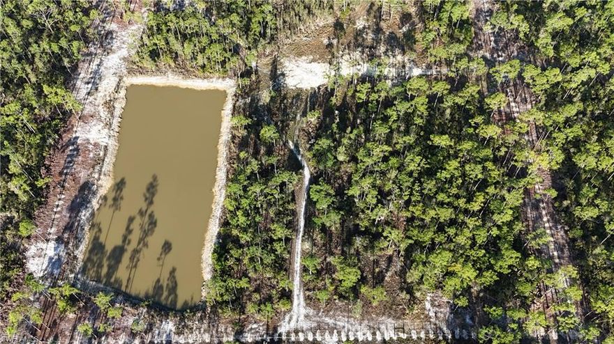 Located along Burnt Store Road in Punta Gorda, this 10± acre property in Charlotte County offers a combination of open land, water features, and privacy suitable for a variety of permitted uses. Zoned for agricultural use, the property provides flexibility for residential construction, small-scale farming, or recreational activities consistent with local regulations. Access to the property is provided via a private road, with an additional gated entrance at Shotgun Road that helps limit through traffic. The parcel itself is fully fenced and includes a front entry gate, offering defined boundaries and controlled access. These features can support livestock management or general land stewardship. A large pond is located on the property, contributing to both functionality and natural surroundings. The water feature may be suitable for livestock, irrigation support, or recreational use such as fishing, depending on buyer preferences and local guidelines. The presence of water also enhances the landscape and provides a natural focal point within the acreage. The land includes a cleared area that appears to be suitable for a future homesite. This portion of the property is described as high and dry, which may simplify planning for residential construction. Buyers should conduct their own due diligence regarding building requirements, soil conditions, and permitting. Surrounding the cleared area, the property retains natural vegetation that supports privacy and a rural setting. The combination of open space and natural cover can accommodate a range of uses such as gardening, outdoor recreation, or agricultural activities. The fencing and layout may also support equestrian or livestock-related operations. Despite its private setting, the property remains within reasonable distance of local amenities. Punta Gorda offers access to shopping, dining, and services, while the surrounding region provides opportunities for boating, fishing, and golf. Nearby coastal access and public waterways contribute additional recreational options. This parcel presents an opportunity for buyers seeking acreage in Southwest Florida with existing infrastructure elements such as fencing, gated access, and a water feature. The agricultural zoning allows for a variety of uses, subject to local regulations and approvals.