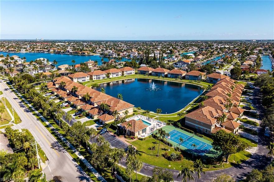Unique second floor villa on Marco Island! Welcome to this gated community, boasting a pristine pool, tennis and pickleball courts perfect for an active lifestyle. This 3-bedroom, 2-bath turnkey villa offers 1,406 sq. ft. of open living space with volume ceilings and serene west-facing lake views.  Just minutes to beach access and the Marco Walk Plaza with dining, shopping, and entertainment, this home also features a private garage for convenient storage. Inside, enjoy a spacious open floor plan, eat-in kitchen, full-size appliances, inside laundry, impact windows and doors, and walk-in closets. The primary bathroom offers a double vanity and shower. Community amenities include a pool, clubhouse, tennis and pickleball courts, walking paths, and BBQ areas all set within beautiful, gated grounds. This villa combines comfort, convenience, and the best of Marco Island living!