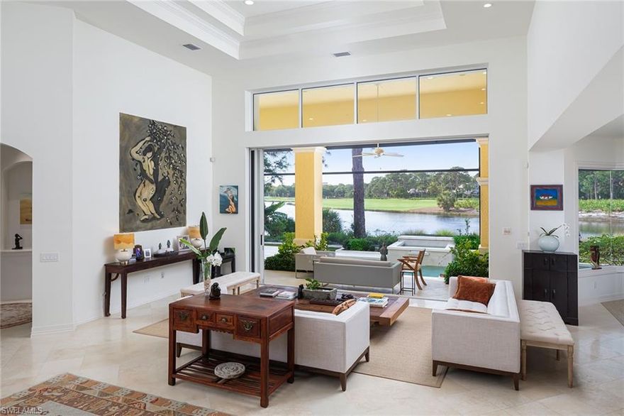 Spectacular forever lake and golf course views in the heart of Collier's Reserve are the backdrop for this stunning London Bay built home. Boasting sophisticated, renovated kitchen and baths, this home offers unparalleled living space inside and out and an open great room with soaring 18-foot ceilings and 10-foot pocket sliders. Renovated cook's kitchen with quartz center island, new Wolf eight-burner stove, Sub-Zero refrigerator and wine cooler. Gorgeous spa-like renovated primary bath with large walk-in shower. The versatile floor plan includes large den with built ins and flex room on first floor and gathering area upstairs with two ensuite guest rooms, large balcony and huge storage room. The timeless travertine floors complementing the wide plank light oak flooring, abundance of windows, natural light and immaculate condition make this sprawling beauty move-in ready. The new roof and picture window screen cage complete the package. As of March 22, there is no one on the Collier's Reserve resident golf membership wait list. Home has third golf cart garage in rear with paved path to driveway. Collier's Reserve is an intimate community with only 224 homes less than two miles from Vanderbilt Beach. Collier's Reserve natural beauty on 450 acres was recognized as the world's first-ever Audubon Signature Sanctuary.