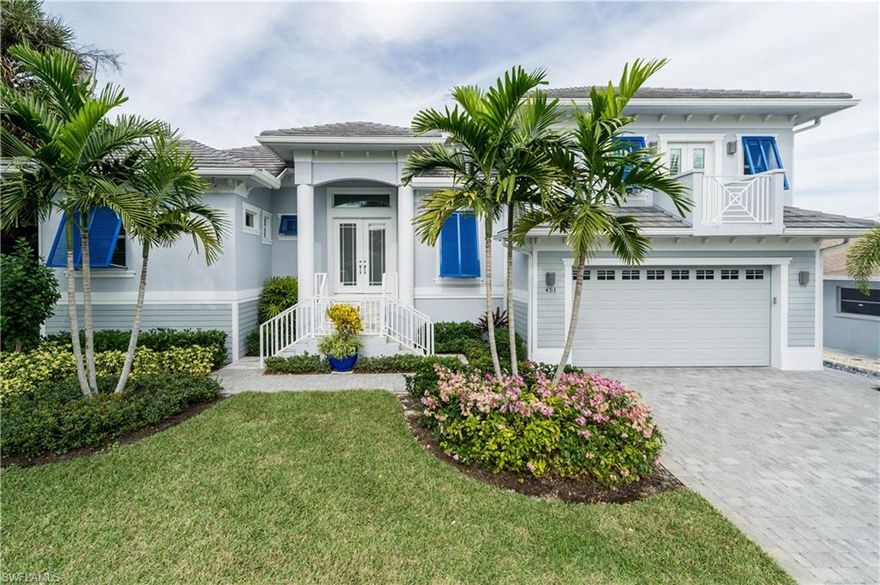 A beautiful West Indies style home with contemporary flair built in 2014. High coffered ceilings, large great room with open kitchen and views of the canal and fabulous outdoor lanai and entertaining areas. A first floor master with large master bath and two walk in closets; an additional first floor guest suite with full bath and two en-suite bedrooms on the second level.  An oversized three car garage with elevator from the garage to the second level. New seawall and new oversize dock with 20,000 pound boat lift. Tastefully decorated with designer finishes. Furnishings available for separate purchase. A resort feel in a perfect location. Great value. Less than 5 blocks to the Beach.