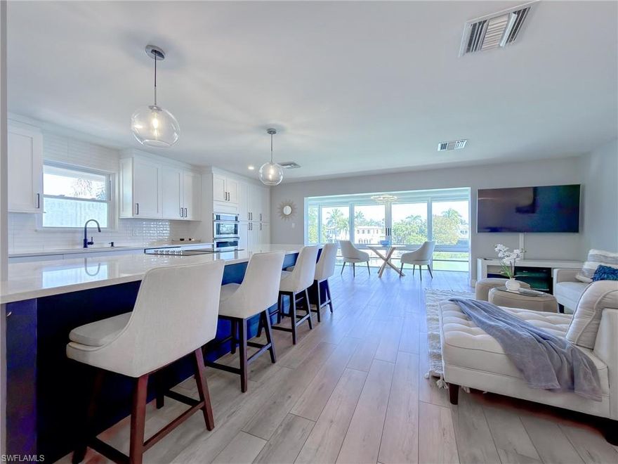 Wake up to sweeping bay views and enjoy being just steps from the sugar-white sands of Naples Beach. This third-floor condo was completely gutted and thoughtfully renovated in 2020, including raising the ceilings to enhance the open, airy feel. The residence features two spacious bedrooms, two beautifully updated bathrooms, and a bright open floor plan centered around an expansive kitchen with quartz countertops and stainless-steel appliances. The enclosed lanai offers flexible living space—ideal for casual dining, a home office, or simply relaxing while taking in the tranquil bay views.

The Ambassador Club offers an exceptional waterfront lifestyle with boat slip rentals available for only $1,500 per year, a floating dock for kayak and paddleboard launching, a heated community pool, on-site management, laundry facilities, a deeded parking space, and eligibility for optional Moorings Beach Park membership. A rare opportunity to own a renovated bayfront residence in one of Naples’ most desirable beachside locations.