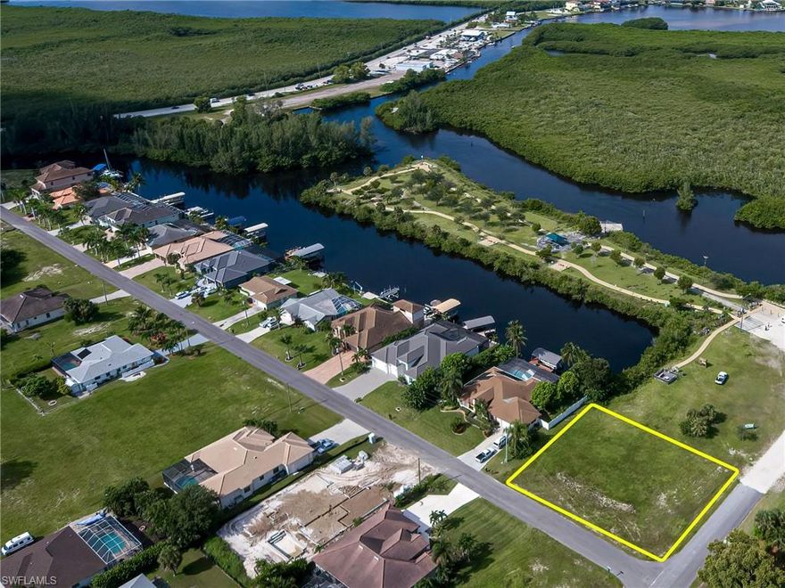 Direct Gulf Access.....This lot in Cape Coral not far from Matlacha has no bridge to contend with. Lot has almost 11' of water frontage.  Great corner triple lot has plenty of space to build whatever you might dream.  Sits next to Sirenia Vista Park with a state of the art boat and kayak launch right in the park, Tons of walking trails, and scenic overlooks.  Also within walking distance to Joe Storis Park with Pickleball, Tennis, and Basketball courts.