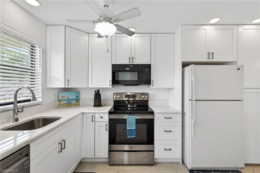 Welcome to Fairways at Par Four, a vibrant 55+ community in the heart of Naples. This well-maintained first-floor residence offers two bedrooms and two baths, highlighted by a bright, open floor plan designed for easy Florida living. The spacious living and dining areas flow seamlessly into a beautifully updated kitchen featuring crisp white shaker cabinetry, soft-close doors and drawers, and elegant quartz countertops. From your screened lanai, enjoy peaceful mornings with a cup of coffee while watching golfers pass by. The primary suite offers a walk-in closet and a private en-suite bath with a walk-in shower. A comfortable guest bedroom and full bath with a tub and shower combination provide the perfect space for visiting family and friends. Tile flooring throughout enhances both style and low-maintenance living, creating a clean, coastal feel. Residents of Par Four enjoy an active lifestyle with a wide array of amenities, including tennis, pickleball, shuffleboard, billiards, a heated community pool, and a full calendar of social events. Exciting enhancements are on the horizon, with the new Gate Golf Club expected in late 2026. This upcoming addition will feature a nine-hole public golf course, illuminated driving range, putting greens, and a bar and restaurant for casual dining and social gatherings. Ideally located just minutes from shopping, dining, and the sugar-sand beaches of the Gulf, this home offers the perfect blend of comfort, convenience, and lifestyle. Don’t miss your opportunity to own a piece of sunny Southwest Florida living