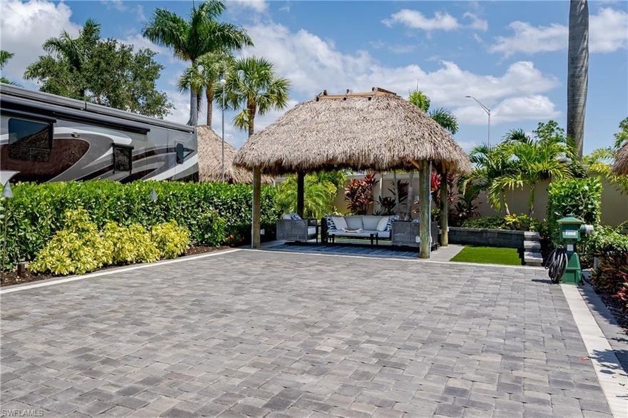 Lot 70 - As you drive in Naples Motorcoach Resort, the first thing you notice is the beautiful landscaping and fountains as you head toward the gates.  Once opened, the gates lead you down beautifully manicured and paved roads to your slice of heaven.  As you back into your property, you marvel at the lush landscaping as well as the sophisticated styling with a mix of beautiful gray and white pavers and top of the line tiles.  Thought was given to having multiple conversation areas, the choice is yours!.  The tiki is amazing with lighting on dimmers to set the exact mood you are looking for. Your property backs to a privacy wall which means you only have two neighbors, one on each side.  But Wait!!!  on the one side is an equally tastefully done property with the same amenities with a walkway between?????  This property was designed by the same owners and is also available!  An opportunity for you to have one of your friends r loved ones own the property next to you.   Or .... buy both and keep one for investment and rent when you don't have a relative staying on it, or keep it as is for the extra space and entertaining.  The opportunities are endless! 

Naples Motorcoach Resort is a Class A only resort and boasts a beautiful infinity pool, hot spa, exercise room, men's and ladies saunas as well as a catering kitchen that owners can use. There are also two satellite pools with a hot spa, their own rest rooms and a laundry room. Three pickleball courts and a community boat ramp where you can explore the canals and head to the Gulf of Mexico.  We can't forget your furry best friend, the resort even has a dog park! Special note to investors, looking for a place to invest or reinvest as a 1031 exchange? Look no further, own this piece of paradise and put it into the management run rental program. The rental program administration advertises, schedules renters, collects payment including applicable taxes/fees and sends you your portion. These deeded lots are mortgage eligible and are great for a quick close.