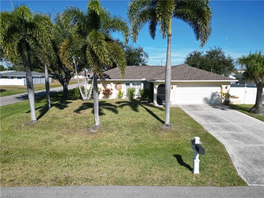 This lovely Cape Coral home would be perfect for the first time home buyer, retiree or the family upgrading to a safe neighborhood with plenty of room to live and play.  This home is also centrally located in Cape Coral where commuting to work via the major throughfares and proximity to shopping is easy.  Besides being in an excellent location, this meticulously maintained three bedroom, two bathroom home with a 2-car garage is simply adorable.  From the moment you walk up to the front door, you will begin to see how cute this home is.  The screened in entry has a small table and two chairs which is a great place to have your morning coffee while watching the world come alive.  Walking into the home, you are greeted with a nicely sized living room which flows seamlessly to the dining area and kitchen.  Adding to the functionality of this home, the master bedroom and bath are on one side of the home and the second and third bedroom and 2nd bath are on the opposite side of the home.  And in the middle is the living, dinning and kitchen.  Just outside the dining area and through the sliding glass door is nicely sized screened-in and covered porch which is a perfect place to have your evening glass of wine.  If I don't have your attention already, this home was constructed on two lots and is a corner lot.  The backyard is huge and perfectly landscaped.  If you didn't know better, you would think it was a park.  The backyard is fenced with maintenance free vinyl fencing for not only privacy but security.  If you need extra parking for a boat or RV, there is ample room on the side of the home behind the fencing.  The roof in only three years old and all the appliances are new.  Simply put, this home has a lot to offer and is being sold partially furnished, so don't be shy, call and make an appointment to see it today.