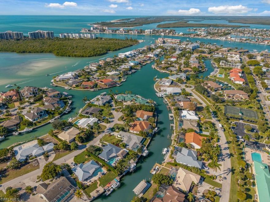 Spacious Florida-style ranch in the Olde Marco Historic District featuring 3 bedrooms each with full ensuite baths and a half bath. The primary bedroom includes a space perfect for a hobby area or study and beautifully updated coastal style bathroom with large walk-in shower and dual sinks. Enjoy multiple living areas for entertaining, the kitchen has warm wood cabinetry and granite counters. The foyer opens to a formal living-dining area. Ample storage and closets thru-out, large laundry area in residence with tackle room leads to a side pathway to the dock. Outside, a covered lanai with a large pool overlooks the canal and backyard with built in steps leading down to the dock. The property also boasts a two-car garage and beautifully landscaped front yard. Eastern exposure direct access property approx. 70x135x89x135 property is a rare opportunity to capture the essence of waterfront living with direct access to the river on one of the most desirable locations on the island, just a half mile distance to 8 local restaurants and attractions. Marco Island offers world-class resort style shopping, fine dining and iconic white sand beaches. Being sold AS-IS.