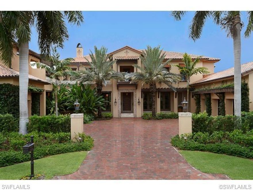 JUST REDUCED & Fabulous! MAKE YOUR BEST OFFER NOW! Owners have moved! An ABSOLUTELY AMAZING transformation of this former London Bay model. This estate residence showcases features not found in most luxury residences to include a commercial depth Koi pond, poolside "Fire Fountains", automatic screen walls & shutters for the entire lanai, glass railings for maximum water & golf course views, state of the art 3-D Theater with touch pad controls, Gated Wine Cellar with barrel vaulted ceiling & Butler pantry, Master bath "Rain Wall",  5 AC units, Lutron lighting & security system. A 2 story Library offers a private elevator to the game room, 3-D Theater & full service bar w/ice-maker, wine cooler, refrigerator & bar stool seating. Penthouse guest suite offers wood flooring, a morning kitchen & is connected to the main residence via a trellised walkway, Ground floor guest suite features wood flooring & shares a gated courtyard, fireplace & fire-pit table with the main house. The kitchen is a work-of-art with Christopher Peacock cabinetry, Carrara marble, imported chandeliers & commercial grade appliances. All this opulence AND long private water & golf course views of the 14th fairway.