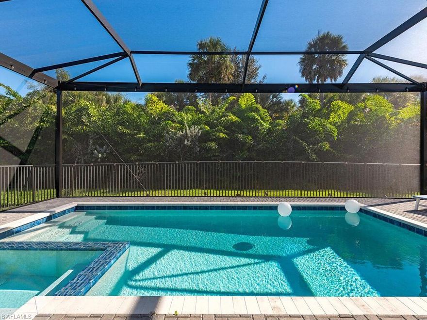 Feel like you’re on vacation every day in this light-filled, nearly brand-new Pelican floor plan home, perfectly positioned with a peaceful preserve at the rear and landscaped green space across the street—so your views are open, serene, and never focused on neighboring homes. Mornings begin with coffee on the three-sided picture-screened lanai as the sun rises over the preserve, and afternoons are best spent floating in your gas-heated saltwater pool, soaking in the spa, or enjoying long, relaxed meals alfresco with friends and family. Beyond the lanai, a fenced yard provides the ideal space for a dog run or defined landscaping—adding both flexibility and function not commonly found in comparable homes. Inside, the bright white kitchen features quartz counters & backsplash, a deep single-bowl sink, pendant lighting, and stainless-steel appliances including a gas range. It opens seamlessly to the great room and dining area, creating an inviting, open floor plan ideal for both everyday living & entertaining. Beautiful oak flooring flows throughout the home—an upgrade that sets it apart from many comparable properties—complemented by ceiling fans and abundant natural light that creates an airy, welcoming atmosphere. Thoughtfully upgraded & meticulously maintained, the home presents as clean, cohesive, and truly move-in ready—without the need for immediate updates or renovations. The private primary suite is a true retreat, offering dual closets and a spa-like bath with frameless shower door and lighted mirrors. The flexible layout includes two guest bedrooms, two guest baths, and a den which works well as a home office, media room, or overflow space for visitors. To make move-in even easier, select furnishings are available for inclusion—an added convenience for seasonal or full-time residents looking for a seamless transition. A prime location within the community offers convenient proximity to the Vanderbilt Beach Road corridor. With planned access improvements expected in the near future, this location is anticipated to provide a more direct route to popular Naples destinations such as Mercato, Waterside Shops, and Venetian Village—enhancing both day-to-day convenience & long-term appeal. This home is well-positioned for both privacy and accessibility. Simple storm prep with impact glass provides peace of mind year-round, and an epoxy-finished garage floor adds a clean, finished touch. Valencia Trails is more than a community—it's a lifestyle. This exclusive 55+ neighborhood features world-class amenities, including a 43,000 SF clubhouse with gourmet restaurant, poolside bar, resort-style pools, fitness center, pickleball, tennis, bocce, yoga, art studio, cooking classes, spa, dog park, and a vibrant social calendar. Unlike many comparable homes, this property offers the rare combination of a private preserve setting, upgraded finishes, and a fully realized indoor-outdoor living experience—delivering both immediate enjoyment and long-term value.