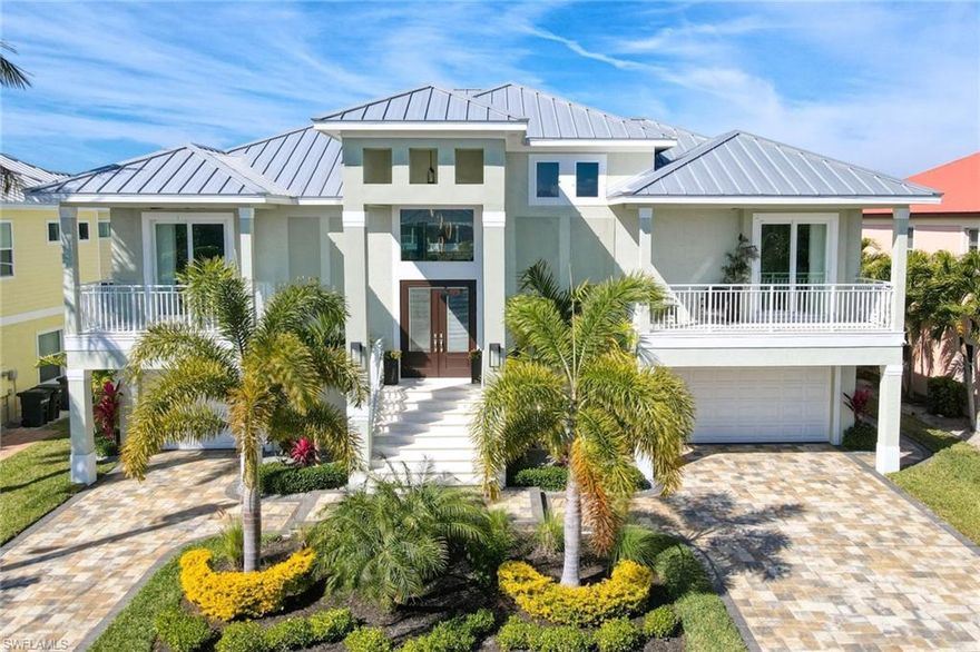 Beautiful newer construction Southwest Florida home located mid island on Fort Myers Beach. Home has much to offer with many upgrades.  Elevator, 12x24 shell stone tile, custom TV/fireplace wall, lutron motorized blinds on back sliders.  Kitchen offers granite, wine cooler, under and above cabinet lighting, glass tile backsplash, stainless steel appliances and linen shaker cabinets with roll out drawers and crown molding.  Enjoy entertaining?  This is the home for you.  8' impact slider doors across the entire back of great room/dining area opening up to screened lanai and outdoor grill.  Enjoy the sonos sound system throughout inside and outside.  Slip down the custom made aluminum stairs to the first level to enjoy your salt pool/spa system with a heat pump, remote pool control, colorlogic light system and the fabulous 2 story clear view pool screen (absolutely gorgeous).   Don't forget to grab a cold beverage at your outdoor wet bar.  Need ice? Steps away the ice machine in garage. First floor outdoor kitchen offers granite, grill, hood, refrigerator sink and glass tile wall.  Take time to relax around the fire pit.  Lumberock dock, water, electric and 10,000 pound lift.