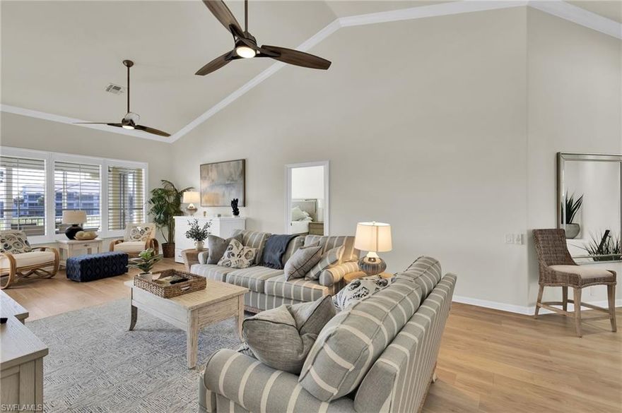 Welcome to this beautifully maintained Nottingham II second-floor bundled carriage home offering 3 bedrooms, 2 baths, and 1,854 square feet of comfortable living in Lexington Country Club in Fort Myers, Florida. With volume ceilings in both the living room and primary suite, this home feels open, bright, and inviting from the moment you enter. Luxury vinyl tile greets you at the entry and stairwell and continues throughout the living areas, den, and bedrooms, while ceramic tile finishes the kitchen and baths. Plantation shutters, upgraded door hardware, and newer ceiling fans create a polished, cohesive look throughout. The completely remodeled kitchen features white shaker cabinetry with decorative upper trim, granite countertops, stainless steel appliances, counter-height bar seating, and a sunny breakfast area. Recent upgrades include a new refrigerator (2026) and new dishwasher (2024, transferable warranty). The spacious primary suite offers a large walk-in closet and an updated bath with dual vanity sinks, separate soaking tub, and a frameless glass walk-in shower with tile surround. The third bedroom features French doors and two closets, including a generous walk-in, providing flexible space for guests or a home office. The guest bath has also been refreshed with an updated sliding glass shower door and tile surround. Step out to the oversized lanai with acrylic sliders and electric hurricane shutters, where peaceful lake and golf course views provide a private, relaxing setting. Manual accordion shutters protect the primary bedroom window. Major improvements include new flooring and paint (2021), new A/C system (2023), new garage steps (2023), and updated fans and hardware (2024). With a one-car garage featuring a front bump-out for extra storage, this 1,854-square-foot carriage home offers space, updates, and bundled golf living in one of Fort Myers’ premier gated communities.