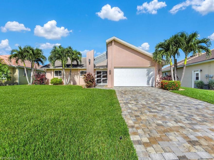 NO FLOODING from Ian due to higher elevation, BRAND NEW ROOF 2022 - Flood insurance is transferrable. Fantastic waterfront setting! Gulf access home w/ panoramic water view right from the front door & offering impact resistant windows/doors, new garage door and motor installed in '21, A/C was replaced in '17, plumbing replaced in '15, living & family room layout, disappearing sliders leading to Florida room from living room, custom desk w/ lots of shelving, vaulted ceiling, breakfast nook & formal dining area, wide galley kitchen w/ breakfast bar, long Florida room w/ enough room for outdoor dining set & lounging area, tile flooring throughout, designer light fixtures & fans, sitting room off of master suite w/ access to Florida room, & large backyard w/ private boat dock, plus there is plenty of room for a pool. Located in one of the most sought out corridors in Cape Coral-right around the corner from the kayaking & nature trails of Four Mile Cove Ecological Park, just minutes away from the open waters of the Caloosahatchee River, surrounded by lots of shopping & dining options, & quick access to the Midpoint Bridge leading to Fort Myers.