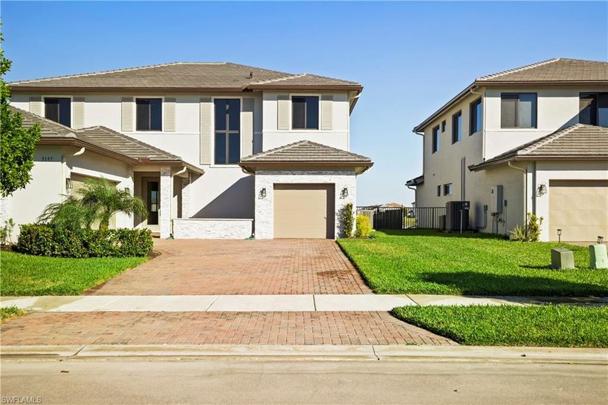 Designed for elevated Florida living, this Inlet model offers the largest floor plan in Maple Ridge at Ave Maria, with over 5,000 total square feet of thoughtfully designed living space. Enhanced with over $200,000 in upgrades beyond the builder’s standard finishes, the home has never been lived in and has been professionally maintained with consistent care throughout, presenting in pristine, like-new condition.

This expansive two-story residence features 4 bedrooms, 3.5 bathrooms, a spacious loft, and a 3-car garage. Each bedroom includes a walk-in closet, providing exceptional storage and everyday functionality. The flexible floor plan also includes a first-floor en-suite bedroom with its own private exterior entrance and a full cabana bathroom, offering an ideal setup for guests, extended stays, or additional household support while maintaining privacy from the main living areas.

Interior highlights include clean architectural lines, a contemporary cable-railed staircase, upgraded finishes throughout, and built-in speakers across the home, creating a seamless blend of comfort and functionality. The kitchen serves as the heart of the home and is designed for both everyday living and entertaining, featuring extensive cabinetry, premium materials, quartz surfaces, and an open layout that connects effortlessly to the main living spaces.

Outdoor living is a standout feature of this property. The lakefront setting frames a heated saltwater pool and spa, complemented by travertine decking, an extended screened lanai, and built-in speakers for indoor-outdoor entertaining. Plumbing and electrical are already in place for a future summer kitchen, allowing the next owner to further customize the space to suit their lifestyle.

Upstairs, the owner’s suite provides a private retreat with generous proportions, dual oversized walk-in closets, and a spa-style bathroom featuring dual vanities, a large tiled walk-in shower, and dual water closets for added privacy and convenience. Additional bedrooms, including a Jack-and-Jill layout with walk-in closets, along with a large loft, offer flexible options for a home office, media space, or everyday living needs.

Located within the Maple Ridge neighborhood of Ave Maria, residents enjoy access to a vibrant, master-planned community known for its clubhouse, resort-style amenities, walking and biking trails, shopping, dining, and a calendar of year-round events. Ave Maria offers convenient regional access, with Weston approximately 1 hour away via I-75 and Naples about 30 minutes away, making it a practical choice for residents who commute regularly across South and Southwest Florida. Homes offering this combination of size, upgrades, lakefront outdoor living, and move-in-ready condition are rarely available.