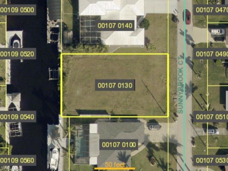 Exceptional opportunity to build your dream waterfront home in the highly sought-after Cape Coral Yacht Club area. This slightly oversized 80 x 135 vacant lot offers direct sailboat access with no bridges to the Gulf of Mexico, ideal for boaters seeking quick and easy open water access. The property features an existing seawall, private dock, and 10,000 lb boat lift, providing immediate value and convenience. Located on a beautiful canal just minutes from the Bimini Basin, this homesite offers western rear exposure, perfect for enjoying stunning Florida sunsets from your future backyard. City water, sewer, and irrigation are already in place, and all assessments have been paid. Surrounded by established homes in a desirable neighborhood, the lot is also close to the Yacht Club community amenities, including the public beach, boat ramp, tennis courts, racquetball, and community pool. One of the few remaining waterfront lots in this prime location.