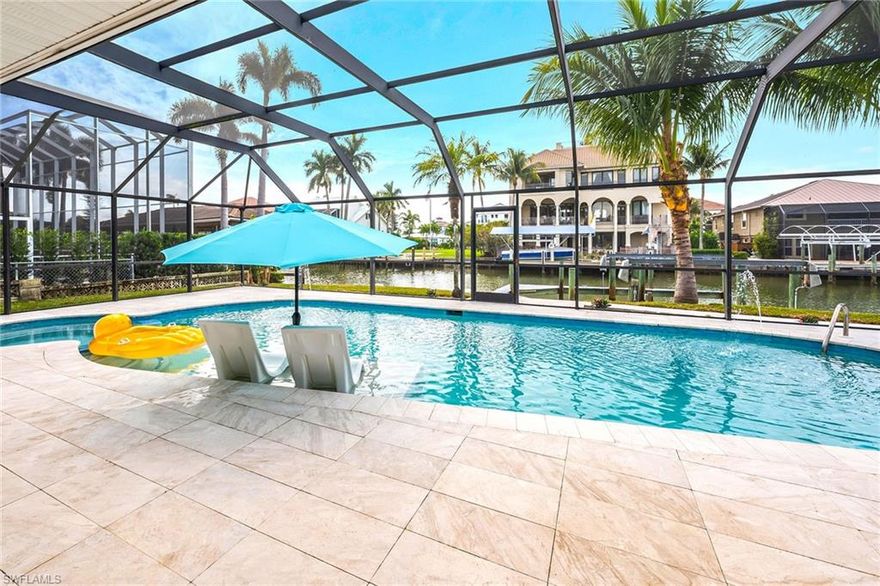 Welcome home to this beautiful Gulf-access retreat in the heart of Vanderbilt Conners. Perfectly positioned with southern exposure, this home enjoys sunshine all day long — ideal for lounging by your sparkling pool or relaxing on the spacious screened lanai with friends and family. A charming brick-paved circular driveway greets you on arrival, leading to elegant glass double doors that open into a bright, airy living space filled with natural light. With its thoughtful updates and open floor plan, this home offers the perfect blend of comfort and coastal charm. Inside, you’ll find three inviting bedrooms and two beautifully renovated bathrooms with heated tile floors, along with modern finishes that make every day feel like a getaway. The chef’s kitchen is the heart of the home, featuring a large marble island, new GE Café appliances, modern cabinetry, and quartz countertops — everything you need for easy entertaining. The spacious living area includes a cozy feature wall with a TV and recessed fireplace, creating the perfect spot to unwind after a day on the water. Enjoy peace of mind with impact windows and doors, a new HVAC system, and a new tankless hot water heater. Step outside to your private backyard oasis with an oversized heated pool and spa and a boat dock for quick Gulf access — boating, fishing, and sunset cruises are just minutes away. The metal roof, fenced yard, and updated A/C and pool heater ensure easy coastal living for years to come. You’ll love being just a short bike ride from Wiggins Pass Beach, The Ritz-Carlton, LaPlaya Beach Resort, and the beloved Turtle Club, plus all the shopping, dining, and entertainment at Mercato and Fifth Avenue South. This home is move-in ready and waiting for you to start making memories — or the perfect canvas to build your dream home in one of Naples’ most desirable neighborhoods. Come experience the coastal lifestyle, where every day feels like a vacation.