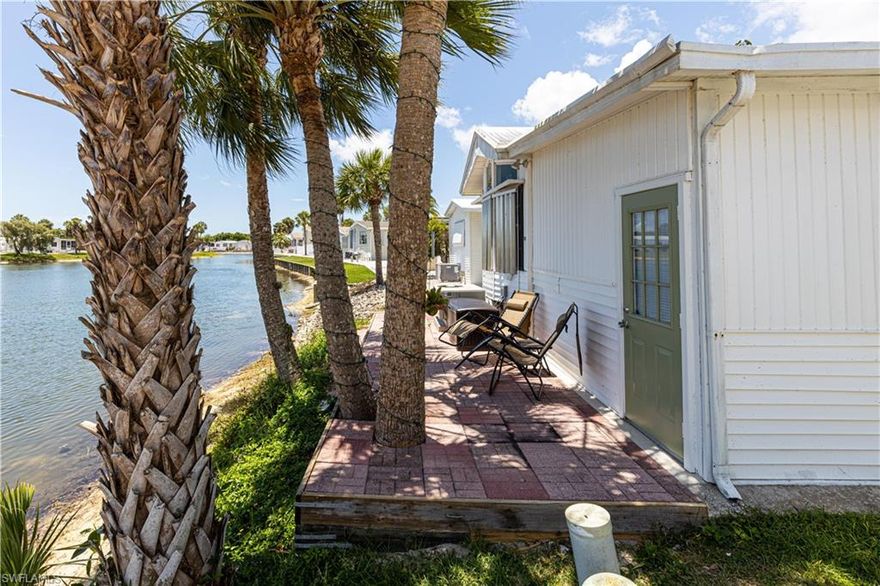 Check out the new price!  This is a very rare 2 bedroom, 2 full bath home in the beautiful community of Imperial Wilderness.  IW is a 55+, active, gated community where you will never run out of things to do.  This home is beautifully decorated with signs of Florida everywhere you look.  And it is on the water!  Picture yourself sitting on the patio under the palms, feeling the breeze off the water, and just relaxing. You will enjoy the extra storage this home offers as well as the very nice tile and wood floors. It is a must see!  The community features 2 large pools, 2 hot tubs, tennis, pickleball, petanque, horseshoes, and so much more.  And don't forget to visit, have a seat, and enjoy the peaceful memorial garden. Less than 5 miles to stores, 10 to Marco Island, and 12 to downtown Naples.