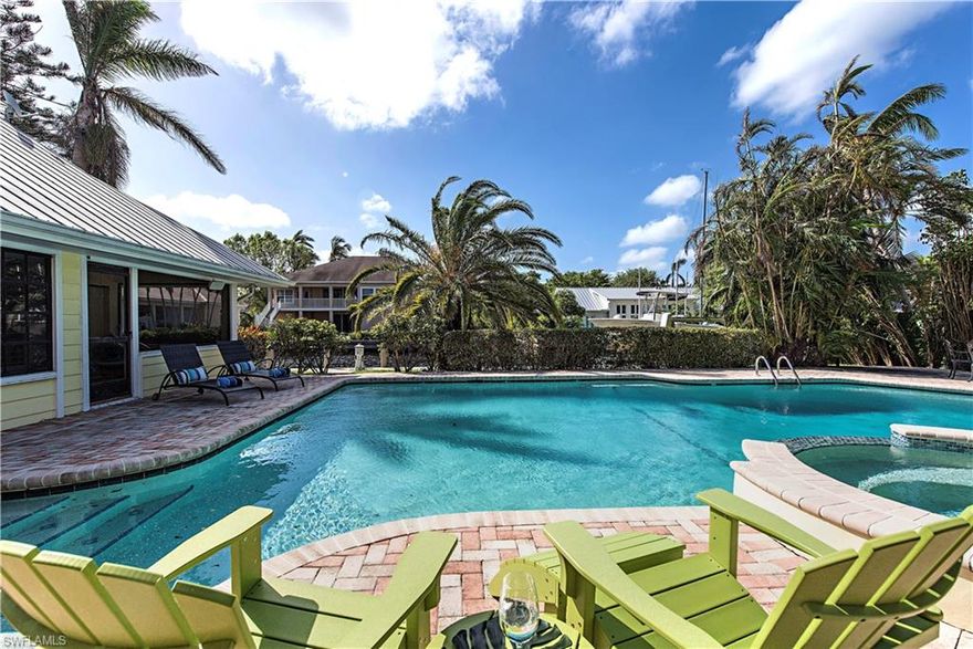 Location...Location...Location! Just 2 blocks to 3rd Street bistros, 3 blocks to the beach, and 14 sites to Naples Yacht Club and Naples Bay. Very quick, no-bridges direct access to Naples Bay. Delightful southern exposure. Huge cathedral ceilinged Great Room with expansive views overlooking 46 ft. pool with cascading spa (electric heater & chiller for hot weather swimming). Wonderful home for entertaining family and friends! Gracious open kitchen with rich warm cherry wood cabinetry, granite countertops, wet bar, walk-in pantry. 90 ft. dock with 13,500 lb. lift. A finest opportunity in the waterfront community of Aqualane Shores. Home was completely remodeled in 2000, Pool was redone in 2015.