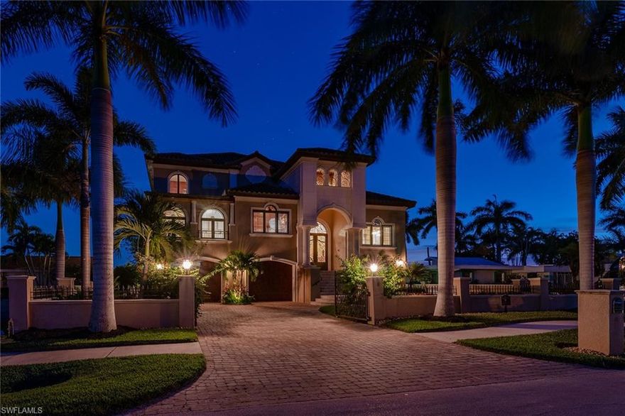 Beautiful views of the Marco River and S.S. Jolley Bridge toward the east, as well as western sunset views of the Gulf from this custom waterfront estate on Isles of Capri. The gourmet kitchen overlooks the water and features a gas stove, high-end appliances and a butler's pantry. This residence boasts 4 bedrooms plus a den, 6 baths, a dining room, a home theater media room, loft and a game room. Full house Generator. The private elevator accommodates from the garage level to the first and second floors. The outdoor living area includes two levels of lanais, featuring a summer kitchen and fireplace. Enjoy the entertaining boat traffic, dolphins, birds and nature from either of the covered porches overlooking the pool, spa and fire pit. Boating enthusiasts will enjoy the dock with two lifts, as well as quick and direct Gulf access. This pristine garage will hold up to eight cars and has two large storage spaces. Construction consists of poured concrete beams and posts, concrete floors on both levels and no exterior lumber utilized.