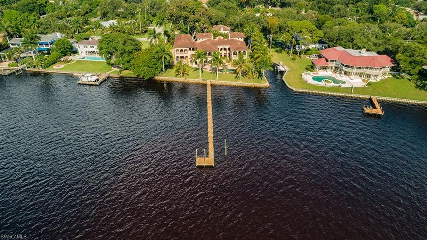 Gorgeous riverfront estate in Fort Myers. 3 story home of  Tuscan design, 8,600sf of AC living space, 15,000sf overall. Perfect home for a large family with 6+BR & 8 BA. Designed by famed, residential designer Bud Lawrence and built in 2009.  Features: 3 tiered theater room with wet bar, 850sf eat in kitchen, 500sf great room rising 28ft to the chandelier & beamed ceiling; wood burning fireplace; exercise room; 3 stop elevator; 11" wide interior walls of textured plaster and 12' high ceilings give a massive feeling to the interior.  Work at home with 1,000sf of office space with hand carved wooden pub bar and fortified hurricane suite.  Alternatively, the home office and adjoining hurricane suite can be a 1 bedroom, 1.5 bath 1,500sf private apartment with separate entrance, for an in-law or adult child returning to the nest.  5 AC units and standby generator.  Fishing pier/dock that extends 200ft into the river! 5,000sf of outdoor living with a pool, spa, gas fireplace, courtyard and outdoor kitchen.  175ft of riverfront plus 197ft on the Carrell Canal. 3/4 acre lot is gated & fenced with monitored security providing privacy and security. The family will enjoy for generations!