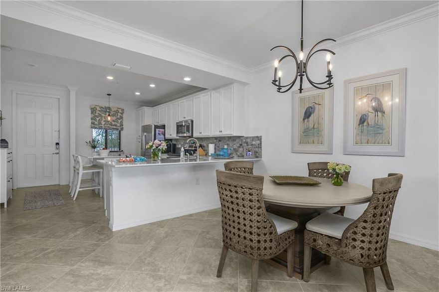 Experience resort-style living in Treviso Bay with this beautifully maintained third-floor, social membership condo at 9572 Trevi Ct #5034 in Naples, Florida. Offered turnkey and move-in ready, this 2-bedroom, 2-bath residence with 1,194 square feet of thoughtfully designed living space is ideal as a full-time home, seasonal getaway, or investment property.

Inside, the home showcases a coastal-inspired design complemented by a long list of tasteful upgrades. The kitchen features a stylish tile backsplash, upgraded lighting, and a new garbage disposal, flowing seamlessly into the dining and living areas where a statement chandelier and decorative cornice above the sliding doors add character and warmth. The primary suite and guest bedroom have been refreshed with upgraded paint, creating light, inviting retreats.

Both bathrooms have been enhanced with brushed nickel faucets, towel bars, and hardware, while the guest bath includes a glass shower/tub enclosure for a clean, modern finish. Additional improvements include replaced water valves throughout, a new pleated shade in the guest bedroom, a peephole added to the front door, and a fan on the screened lanai. The lanai is further upgraded with no-see-um screens, making it the perfect spot to enjoy peaceful mornings and breezy evenings.

Located within the highly sought-after, gated community of Treviso Bay, residents enjoy a true resort lifestyle. Amenities include a stunning resort-style pool with waterfalls, poolside restaurant and bar, state-of-the-art fitness center, aerobics studio, full-service spa, tennis courts, pickleball, bocce, walking and biking trails, and a vibrant calendar of social events. A social membership provides access to these world-class amenities without the added expense of a golf membership, but the extraordinary private TPC golf course in the community is available to social members off-season from May - October..

Conveniently situated just minutes from downtown Naples, Fifth Avenue South, Marco Island, and the area’s renowned beaches, shopping, and dining, this condo offers the perfect blend of comfort, convenience, and Southwest Florida lifestyle. Whether you’re looking for a low-maintenance seasonal retreat or a full-time residence in a resort-style community, this Treviso Bay condo checks all the boxes.