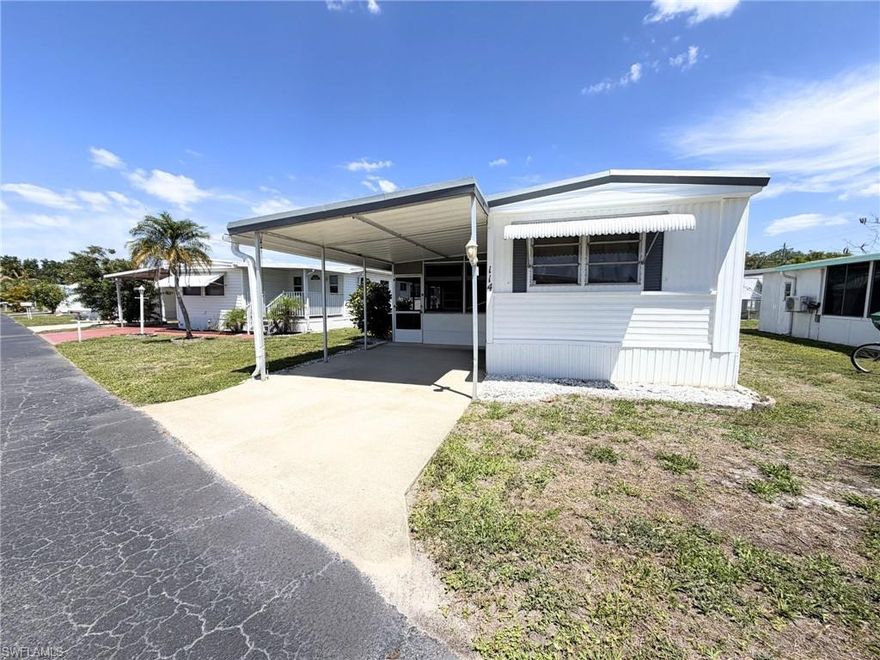 Affordable Naples living with GULF ACCESS!! Welcome to this well-kept 2 bedroom, 2 full-bath home in the Holiday Manor 55+ BOATER-FRIENDLY community! A covered car part gives you space for 2 vehicles, or boat storage. Inside, you’ll find VINYL FLOORING throughout, giving the home a cohesive, low-maintenance, and updated feel. Offered PARTIALLY FURNISHED with a washer and dryer included, this home is ready for an easy move-in. But the real highlight is the outdoor living—enjoy your spacious screened-in lanai, the perfect spot to sip your morning coffee, unwind in the evenings, or host friends while enjoying the Florida breeze year-round. Just beyond, an outdoor workshop provides extra space for hobbies, tools, or storage, adding both function and flexibility to your lifestyle.Holiday Manor is a vibrant, active 55+ community offering direct GULF ACCESS with boat docks, land storage for your boat, and a private boat launch. The community boasts resort style amenities including a heated pool, hot tub, shuffleboard courts, billiards room, rec hall, community laundry room, exercise equipment, horseshoe and cornhole area, a screened gazebo by the water, and weekly and monthly activities—embracing the true Southwest Florida lifestyle. All of this with LOW HOA Fees! Ideally located between Naples' 5th Ave and Marco Island, and just minutes from I-75, this location can't be beat. Whether you're seeking a seasonal retreat or a full-time Florida residence, this home checks all the boxes. Don't miss this incredible opportunity!