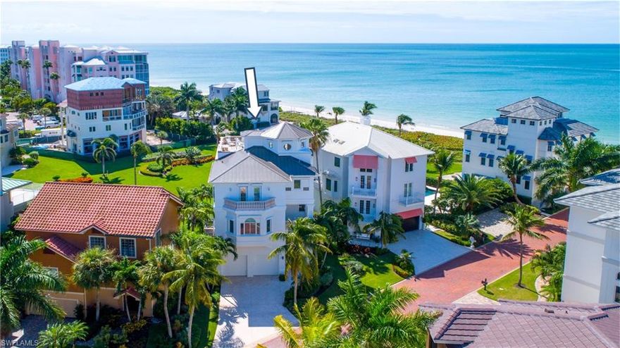 Barefoot Beach estate with breathtaking Gulf view, in one of the best gardens, with unbelievable rooftop deck overlooking the beach. Enjoy Gulf breezes from your private rooftop deck, one of the largest outdoor entertainment spaces in any Barefoot Beach home. Southwest exposure offers gorgeous natural light & stunning sunsets over one of the finest Gulf views in the neighborhood. This North Naples home offers the best of both worlds—Beach & Boating! Separate Gulf-access boat slips available for purchase just steps away*. This ALL CONCRETE home boasts a 2018 new metal roof, 3 new 2016 A/Cs, impact resistant doors/windows, electric shutters, new Lutron light system, elevator to all floors (inc. rooftop deck), new $7K landscaping, new central vac & all new paint in/out. Excellent floor plan with 2nd bonus entertainment room, balconies on each level & garage with room for 3 cars. Barefoot residents enjoy clubhouse with tennis & fitness center, 3 miles of beachfront & manned gate. The OPTIONAL “Club at Barefoot” offers boat slips, tennis, 2 restaurants, private pool & beachside food/beverage/chair service. Prime Collier County location minutes to Mercato, Waterside & easy access to RSW.