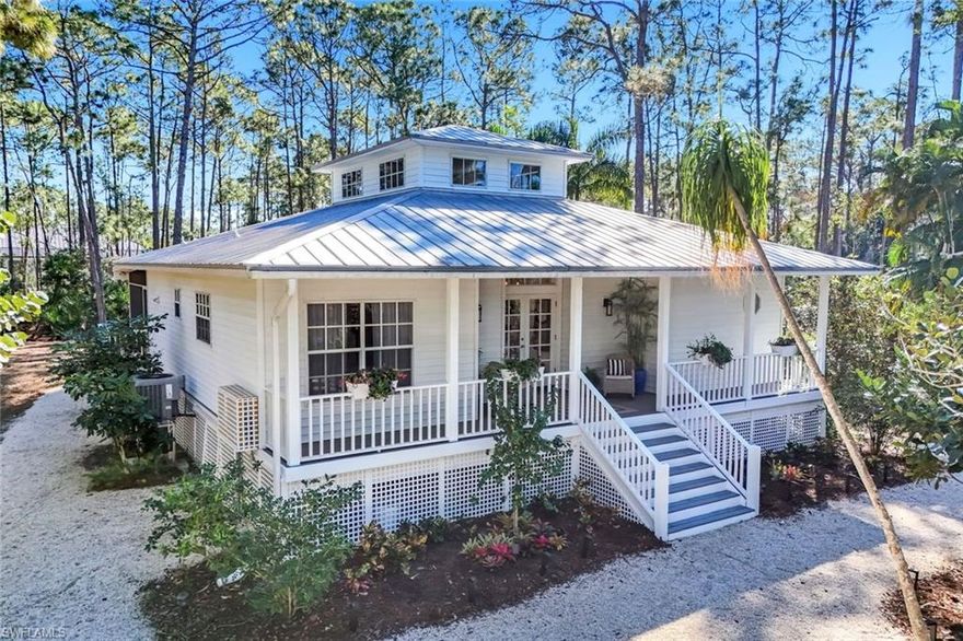 FRESHLY RENOVATED dream cottage on 1.25 acres of private and naturalized 100% uplands. Truly a nature lover’s paradise, this picturesque Florida home leverages an abundance of outdoor living space and windows for a sense of connection to the peaceful setting from all angles. Completely fenced including gated entry, front and rear porches overlook expansive, low-maintenance wild spaces, flower beds, and butterfly garden with all the magnificent local wildlife we cherish. Seating areas and fire pit are conveniently distributed around the outdoors, with plenty of room to add a pool or store that boat, RV, or toys free from HOA restrictions. Renovations to the cottage began in 2022 and have been comprehensive. Highlights include a designer white shaker kitchen with market-favorite quartz counter top, waterfall edge, and matching quartz backsplash with all newer stainless appliances; fully reimagined primary suite with fresh oversize marbled tile, free-standing tub, and quartz double vanity; enormous screened rear porch which doubles as an extra family room and dining space for four-season enjoyment; popular wood-look LVP plank flooring throughout living spaces and bedrooms; re-pipe and pest prevention system; newer hot water heater; new HVAC; and freshly serviced metal roof with new screws and seals, expected to last 10+ years. Home is located in optimal flood zone “X” with no flood insurance requirements or history of flood or hurricane damage, and seller will provide a complete inspection report performed 1/30/26 for additional peace of mind and savings. San Carlos Estates is a rare pocket of non-gated, non-HOA land, where homeowners enjoy large lots, privacy, and freedom, while being just moments away from all the dining, shopping, healthcare, and conveniences shared with the neighboring world-class gated communities. The Estates has a charm and sense of community unique to the area, with many homeowners electing to use golf carts to scoot around (and merrily parade down Strike Lane for the winter holidays and Halloween), and is one of the few local communities permitting equestrian use, agricultural use, and select home-based businesses. It’s a transitional community where multi-million dollar custom homes are the new norm, but it still manages to remain casual and retain its country charm. Come explore today!