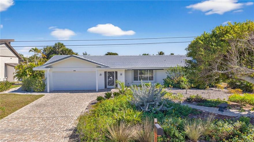 Tucked away in a quiet near-beach community on the desirable east end of Sanibel Island, this beautifully updated 4 bedroom, 3 bath canal-front home offers the best of island living—where boating days and beach sunsets are simply part of everyday life. With deeded beach access and private parking, you can easily enjoy both the Gulf and the waterway right from your neighborhood.

Inside, the home welcomes you with a bright, open floor plan and desirable split-bedroom layout, all finished with elegant porcelain tile flooring designed for easy coastal living. The spacious kitchen is made for gathering, featuring a breakfast bar, quartz countertops, white shaker cabinetry, and a sliding pass-through window that connects seamlessly to the pool patio—perfect for effortless indoor and outdoor entertaining.

The living and dining areas flow naturally to the expansive screened lanai where a heated pool and convenient pool bath create a private outdoor retreat for year-round enjoyment.

Boaters will appreciate the canal frontage with private dock and 14,000-pound boat lift, providing quick access to open water for fishing, cruising, or sunset rides through the mangroves.

With four comfortable bedrooms thoughtfully positioned for privacy, generous living spaces, and a layout designed for both relaxation and entertaining, this home is being sold furnished, making it truly move-in ready for immediate enjoyment as a primary residence, vacation home, or investment property.

Just a short walk or bike ride to the beach, yet perfectly positioned for life on the water—this is the Sanibel dream.