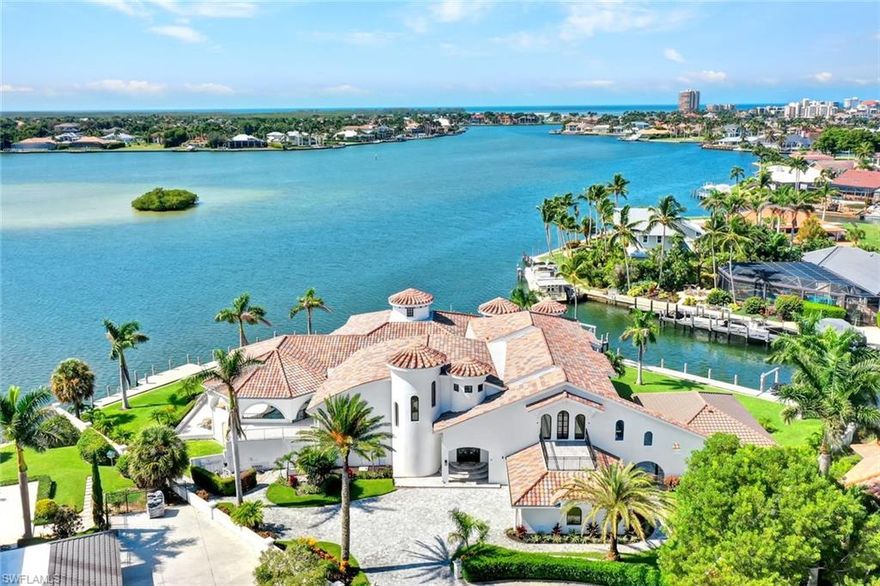 Villa Italia is the most exquisite and coveted waterfront mansion on Marco Island. Immerse yourself in luxury and privacy at this sprawling grand estate built on a rare oversized .78 acre tip-lot. This unique home features breathtaking southern facing panoramic views of Roberts Bay and an unparalleled 356ft of water frontage. Upon entering this magnificent residence, you will be captivated by its open living area with soaring ceilings, exquisite details and quality construction, including a large wine cellar, home theater, gameroom and more. The Italian-style gourmet kitchen is perfect for entertaining and a chef’s dream, equipped with SubZero-Wolf appliances, sleek quartz countertops, and custom cabinetry. This extraordinary estate is well-designed with 6 ensuite bedrooms in the main residence and a separate guest house complete with its own bedroom, kitchen, & full bath. The lavish pool & spa have a secluded, tropical, resort-style feel with an abundance of outdoor living space and manicured gardens in the rear of the home overlooking vast water views. This luxurious paradise is a yachtsman’s dream with direct access, minutes to the Gulf and boasts an expansive dock, 2 boat lifts, jetski/kayak platform, and can easily accommodate a formidable yacht. This is an incredible opportunity to own and enjoy a one-of-a-kind extravagant estate.