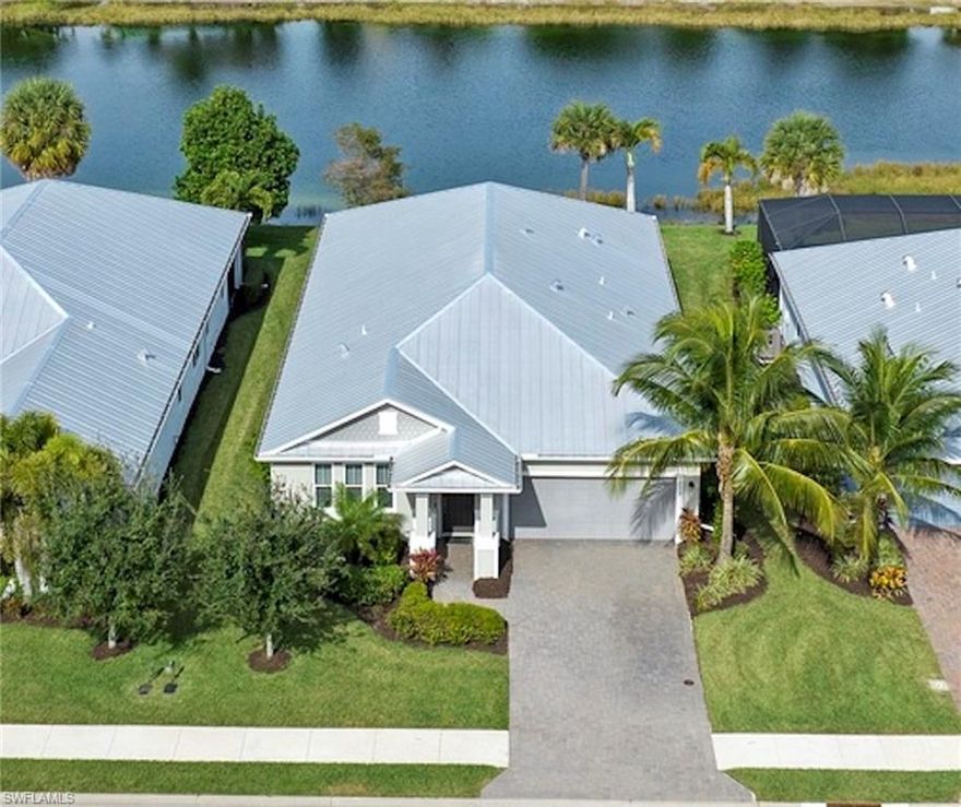 WATERFRONT LOT. Large OPEN FLOOR PLAN home with 4 beds & 3 full baths, large entertaining NOSEEUM screened lanai with OUTDOOR KITCHEN rough-in. IMPACT GLASS WINDOWS/DOORS, Kevlar screen storm shutters. Spacious great room/dining/kitchen with tray ceiling, CROWN MOLDING, TILE floors, custom lighting & fans throughout. Gourmet kitchen with upgraded cabinetry, EXTERNAL VENTED RANGE HOOD, SS appliances, QUARTZ counters, tile backsplash, breakfast bar & pantry. Large primary suite with tray ceiling, LVP floor, fan & bath with double sinks, large tile shower, water closet & WIC closet. Guest bedroom with ENSUITE BATH. Laundry with cabinets & washer/dryer. RING doorbell & garage keypad entry. 2-car garage with attic stairs, workbench/storage, DEEP FREEZER, portable GENERATOR & dedicated generator outlet. Plenty of room to add a caged pool/spa. TRANSFERRABLE low payment flood insurance policy in place. Amenities include guarded gate, resort style pool & lap pool, cafe, tiki bar, beach, dog parks, playground, bocce ball, fitness center, Tennis, pickle ball, bike/walking trails, 1-mile rowing lane, etc. Low HOA fees!