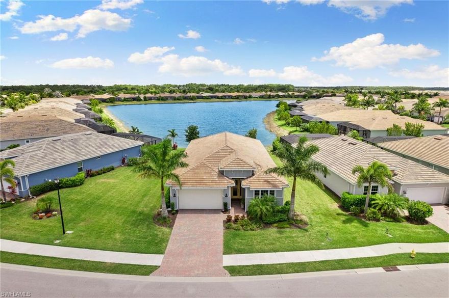 Breathtaking direct lake views, combining luxury and tranquility in perfect harmony. Situated on a spacious pie-shaped lot with coveted southeast exposure, this home provides both privacy and a front-row seat to serene water vistas. As you enter, a welcoming foyer opens into an expansive living area, where tray ceilings and an abundance of natural light create an atmosphere of elegance. The open-concept design effortlessly connects to the upgraded kitchen, equipped with top-of-the-line appliances, custom cabinetry, and a large island ideal for culinary enthusiasts and entertaining guests. The master suite serves as a private sanctuary, featuring tranquil lake views, tray ceilings, and a luxurious ensuite bathroom complete with Toto comfort height toilets. Additional bedrooms are designed with comfort in mind, offering ample space for family or guests. Step outside to the extended lanai, where you'll discover a peaceful oasis with uninterrupted lake views. The screened-in patio, fitted with a no-see-um screen, allows you to relax and unwind while enjoying the stunning scenery without any distractions. This residence also includes an extended tandem garage, providing ample room for parking and storage, ensuring convenience for homeowners.
Naples Reserve offers a lifestyle like no other, with an array of thoughtfully curated amenities. The community is centered around its tranquil lakes, with the exclusive Island Club, resort-style pool, and tiki bar & café providing spaces for relaxation and socializing. Outdoor enthusiasts can enjoy bocce ball courts, outdoor fitness stations, beach volleyball, and miles of walking and biking paths. There’s also a boat ramp for easy water access and two large dog parks for your furry companions. Sports facilities, including basketball, tennis, and pickleball courts, cater to an active lifestyle, while the children's play area and onsite property management ensure that every need is met.
Experience unparalleled luxury and the beauty of lakeside living at Naples Reserve, where every detail has been meticulously crafted to elevate your lifestyle.