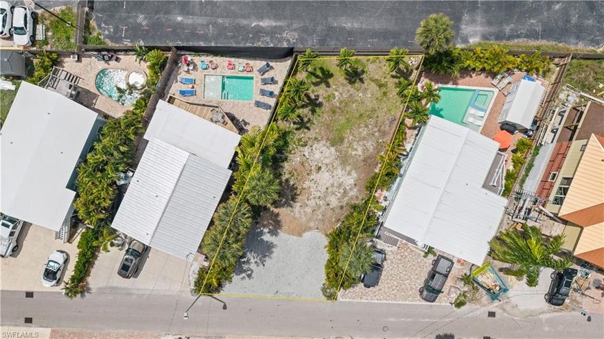 Build your dream home within easy walking distance to the beautiful sugar white sands of Fort Myers Beach. Located in the coveted weekly rental zone, this lot offers privacy but close enough proximity to the fun of vibrant restaurants, bars, and shops of Fort Myers Beach. There is a boat ramp at the end of the street providing easy access to the bay and Gulf. A short walk to  Beach Access #31 provides your route for a sunset walk to Margaritaville and beach bliss!
