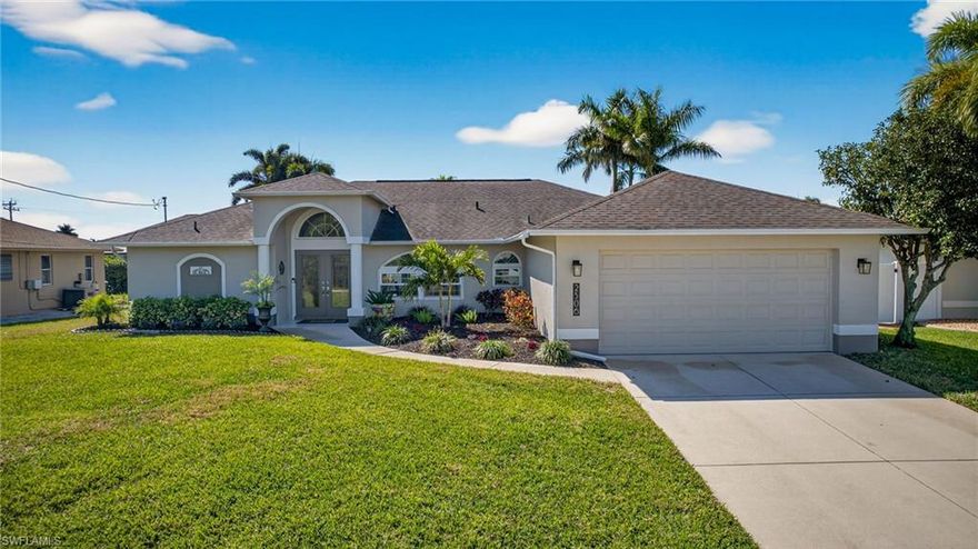 Wow! Here you go...This absolutely stunning, recently renovated, "TURN-KEY FURNISHED" Cape Coral Pool home REQUIRES NO FLOOD INSURANCE ~ NO HOA FEE'S ~ NO CDD FEE'S & CITY WATER & SEWER ASSESSMENTS ARE PAID IN FULL*** Step into your dream home thru the double glass entry doors & be greeted by the abundance of natural light & expansive vaulted ceilings while immersing yourself into the essence of sunny SW Florida living! Complete with a "Florida Coastal" vibe decor, this spacious property boasts 2373 total square ft with 1932 square ft under air while offering unparalleled SOUTHERN EXPOSURE sunset views & enjoying all day pool sun! Every detail has been carefully considered as this fabulous gem was designed for comfort & hosting large gatherings with family & friends featuring 3 spacious bedrooms / 2 full baths along with both a great room & family room, which includes a brand new 85" HD TV for enjoying movie nites & watching sporting events. Do you like to entertain? Step into the inviting fully screened lanai w/ pocket sliders, perfect for entertaining, al fresco dining, grilling out, enjoying cocktails on the custom surf-board table, relaxing in the refreshing, solar-heated pool or unwinding in the newer Six person jacuzzi spa. Inside, the home is appointed with the finest upgrades including a chef's inspired kitchen with real wood cabinets, quartz countertops, high-bar w/ stools, breakfast table for 4 & newer Samsung high-end blue stainless steel appliance package. The primary bedroom features a King size bed w/ 70" HD TV, large private "en-suite' custom bath, over-sized walk-in steam shower, dual sinks, crown molding, modern tile & plenty of closet space. Additional Property features that add to the home's allure include: Two spacious guest bedrooms w/ King & Queen beds each w/ large HD TV's ~ Professional Interior & Exterior paint ~ Designer Life-proof plank flooring alongside 24" porcelain tile ~ Formal dining area ~ Hurricane impact glass windows ~ Private interior laundry room w/ upscale Samsung washer & dryer ~ High-end light fixtures & ceiling fans ~ Double entry doors ~ Meticulously landscaped grounds ~ Spacious 2 car garage & much, much more! ***Located across the street from Joe Coviello Park, this popular nature preserve offers walking trails, boardwalk, sightseeing and family picnic shelter. Discover why this immaculate home tucked away in a quiet SW Cape Coral neighborhood conveniently located near popular Restaurants, Shopping, Schools & Service Businesses is the epitome of SW Florida living at its finest! ***Perfect for primary residence ~ 2nd home vacation property ~ Investor AirBnB rental income property....***Check out the Virtual Tour link****Schedule your private showing today!