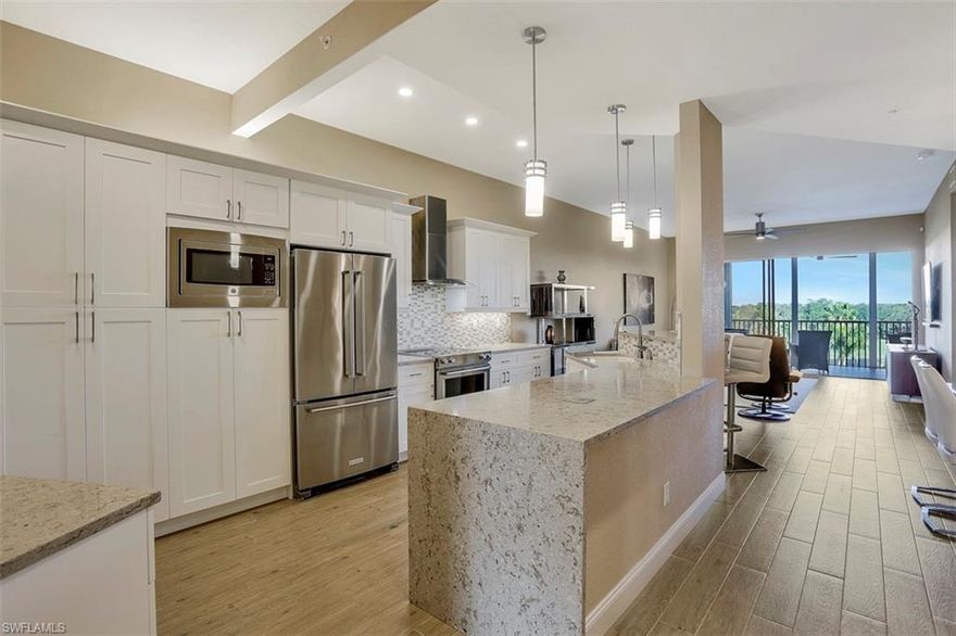 C.16898 - Move right in to this beautifully renovated 4th floor golf course and lake view FURNISHED condo in popular Pebble Creek in Pelican Bay.  The kitchen was opened up and expanded, providing plenty of storage and workspace for the cook in the family.  The kitchen features white shaker style cabinetry, Pompeii Quartz countertops with a waterfall edge and an integrated wine refrigerator.  Both bathrooms were also completely updated, with the master bathroom being reconfigured to provide a large shower and abundant storage.  You will appreciate the wood plank tile flooring, new carpeting in the two guest bedrooms, new light fixtures, new outdoor kitchen and the electric rolldown hurricane shutters on the lanai.  This property also comes with an oversized under building one car garage. Pelican Bay is Naples’ premier mixed-use beachfront community, offering its members a preeminent lifestyle that cannot be found elsewhere Florida, including private beachfront restaurants, beach services, tennis courts and pro shops, full service fitness center, community center, canoes and kayaks, sailing, wellness studio and nutrition and health services.