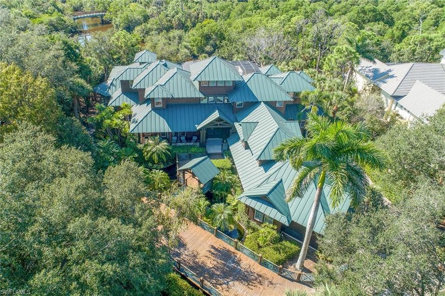This historically-based Olde Florida home, built by London Bay Homes, exudes old-fashioned charm while providing all the comfort and amenities of a contemporary luxury home. It has won numerous design awards. A boardwalk over a flowing koi pond leads to the welcoming front entryway. In homage to this architectural style, the floor plan is open and airy with features that include large wrap-around verandas, cupolas atop high pitched ceilings, metal roof, an abundance of light, clerestory windows, a crows-nest and sweeping waterfront vistas of the Cocohatchee River from nearly every room. Two private river docks accommodate small boats or jet skis. Planned as a tropical lagoon, the swimming pool has tiny waterfalls and cascades downward toward the riverfront in a series of smaller pools. Adjacent to the newly remodeled kitchen is an extra-large walk-in pantry and butler's pantry. Location is within driving minutes to beaches, fine dining, shopping and 30 minutes to SW Florida International Airport.
