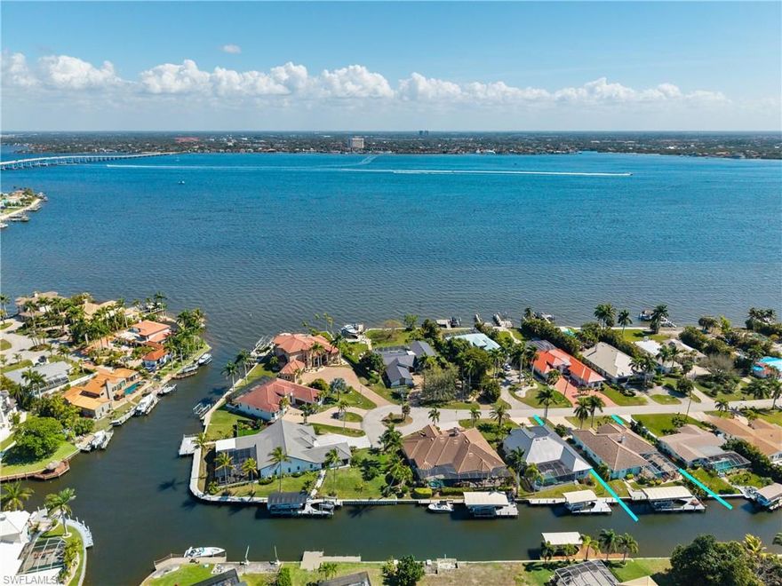 DIRECT GULF ACCESS just minutes to the river and a short boat ride to the Gulf — welcome to Nautilus Drive, a quiet waterfront-only street in one of Cape Coral’s most desirable boating neighborhoods. This beautiful 3 br+den, Gulf-access pool home offers the ideal blend of location, lifestyle, and thoughtful upgrades, making it a standout opportunity for both end users and investors. From the moment you step through the double front doors, soaring ceilings and an expansive open layout create a bright, airy feel throughout the main living areas. The redesigned kitchen serves as the heart of the home, featuring solid wood cabinetry, granite countertops with impressive detail, stainless steel appliances, a Bosch dishwasher, hidden cooktop exhaust, and a large movable island perfect for gathering and entertaining. The living spaces transition seamlessly to the oversized lanai, creating effortless indoor-outdoor living.
Major improvements include a tile roof, complete plumbing re-pipe, refinished saltwater pool with water feature, updated pool heater, refreshed bathroom vanities, a wheelchair-accessible shower, expanded living area, paver driveway, re-decked dock with canopy, 12,000-pound boat lift, and fencing for added privacy. The HVAC system has also been replaced. The spacious paver pool deck and generous covered lanai overlook lush tropical landscaping and fruit trees, creating a private, resort-style setting designed for relaxation after a day on the water.
With true direct Gulf access, extensive upgrades, and excellent seasonal and annual income potential, this property presents an exceptional opportunity whether you’re searching for a full-time waterfront residence, winter retreat, or income-producing investment. This is Cape Coral boating at its best. NO FLOODING EVER IN THIS HOME!