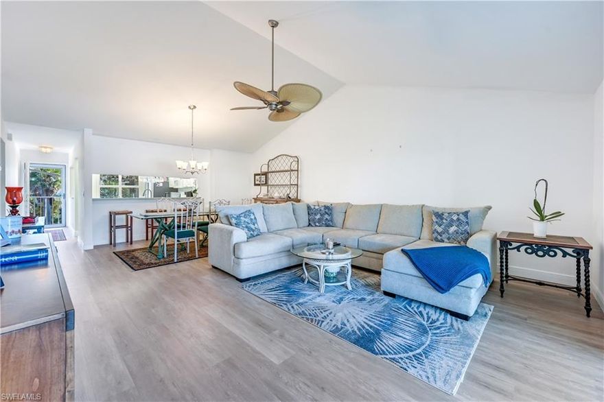 RARELY AVAILABLE EXTRA WIDE TOP FLOOR UNIT. Located in the beautiful Naples Sandpiper Bay Club Community, is this well maintained and move-in ready condominium. This top floor, EXTRA WIDE unit, with impact storm windows, has two bedrooms; two bathrooms and larger lanai, which is glass enclosed. The great room has vaulted ceilings and has extra large living space, approx 17' x 26'. The kitchen features some stainless steel appliances, upgraded cabinets, Corian countertops and reach-in pantry. The primary bathroom has a glass-door enclosed shower, separate vanity area, & walk-in California closet. The guest bedroom has a reach-in closet. The guest bathroom has updated vanity & shower/tub combo. There is extra storage in the Laundry room, equipped with cabinets and a countertop for your convenience. Enjoy the serene setting, all year long, from your glass enclosed; screened lanai. LVT flooring throughout. All of the windows have plantation shutters. The lanai has a tile floor. This  community offers 2 (heated) pools, clubhouse, BBQ areas, private community boat docks that periodically become available for purchase. Gulf access; no bridges. There is 1 assigned parking space & available guest parking.