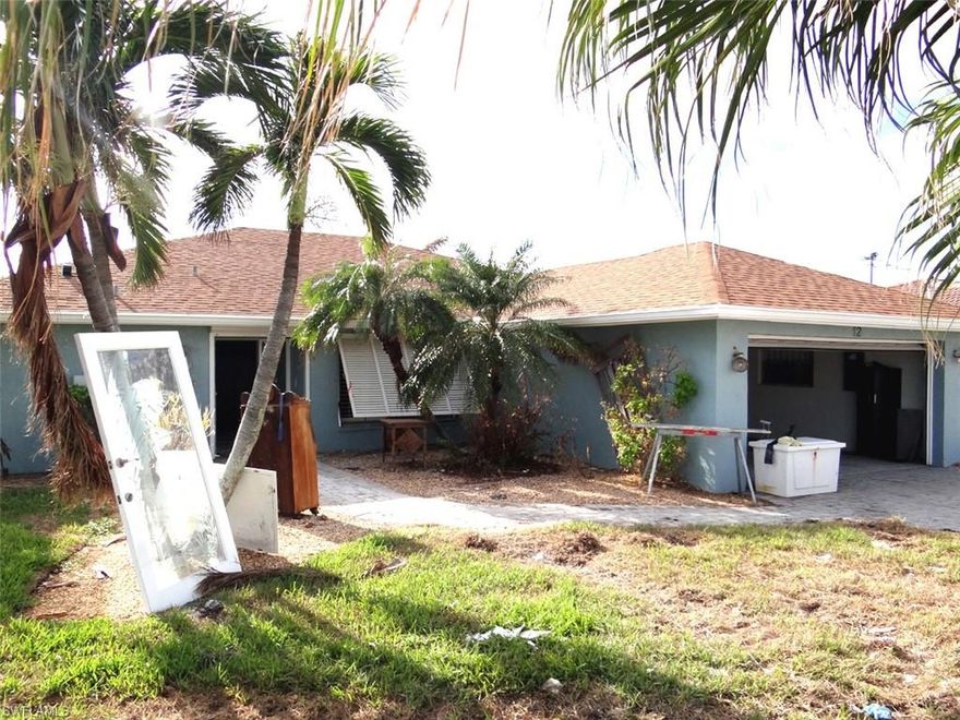 It’s time to rebuild the dream.  This 2 bedroom plus den, 2 bath canal home was visited by the flood waters of Hurricane Ian. Like many others on Fort Myers Beach, it had water damage but has been inspected by a licensed agency and certified structurally sound. The damaged drywall has been removed and it will be ready soon for interior renovations. Nearly all of the attractive landscaping remains intact. The pool was Star Brite resurfaced in 2013 and the pool cage has only minor damage and will need to be rescreened. A new substantial seawall was installed in 2019 and there is a walk around U shaped dock with electric boat lift. The home offers highly desirable travertine tile flooring throughout.   Pre Ian pictures show the dream that was.  Post Ian pictures show the after storm opportunities.  Put your imagination and dreams to work as you add your creative touch in reclaiming this exceptional property located in the desirable Fairview Isles community, with direct access canal,  just a shorth boat ride along the scenic Estero Bay to Gulf fishing and recreational activities.