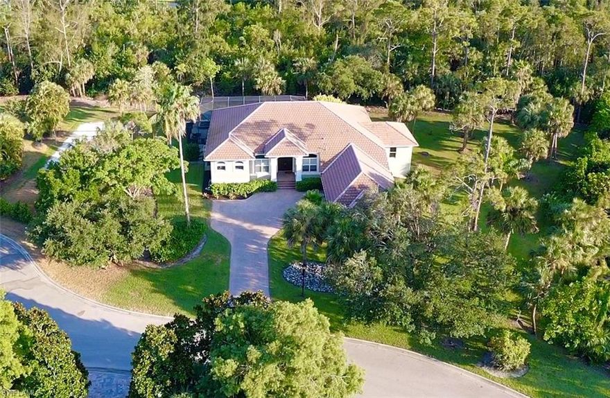 Welcome home to this private oasis on over an acre of land in the highly sought-after gated community of Devonwood Estates. Completely renovated over the last 2 years, this home is upgraded with all the high-end modern details you desire and is move-in ready. Nestled at the end of a cul-de-sac, the shape and size of this lot give complete privacy to the pool and screened-in lanai while backing up to miles of Estero preserve that will remain undeveloped for your seclusion. Zero/corner-door sliders pocket open to let the peace of nature and light fill the great room and kitchen to maximize the indoor-outdoor living that Florida offers. The chef's kitchen features natural exotic stone countertops, a gas range, a hidden coffee bar and an exceptionally large walk-in pantry. Adjacent is the custom temperature-controlled wine room with a floor-to-ceiling glass display. The yard features a private volleyball court and fruit trees for your enjoyment as well. This affordable price point within the gates is a rarity you will want to act quickly. Call to set up your private showing.